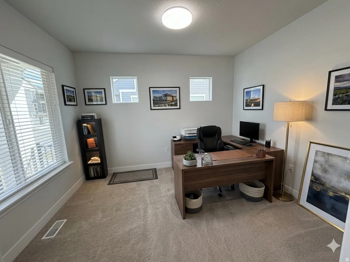 Office featuring light carpet and baseboards