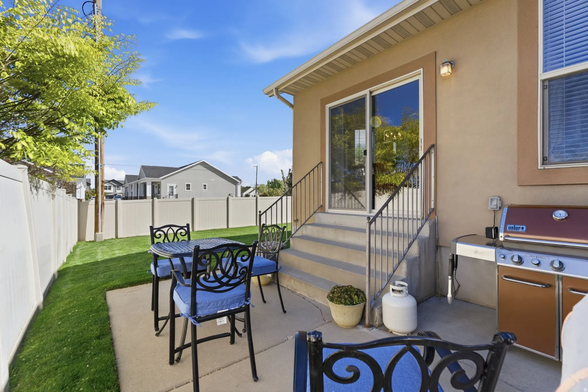 Fenced backyard featuring a patio, outdoor dining area, area for grilling, and entry steps