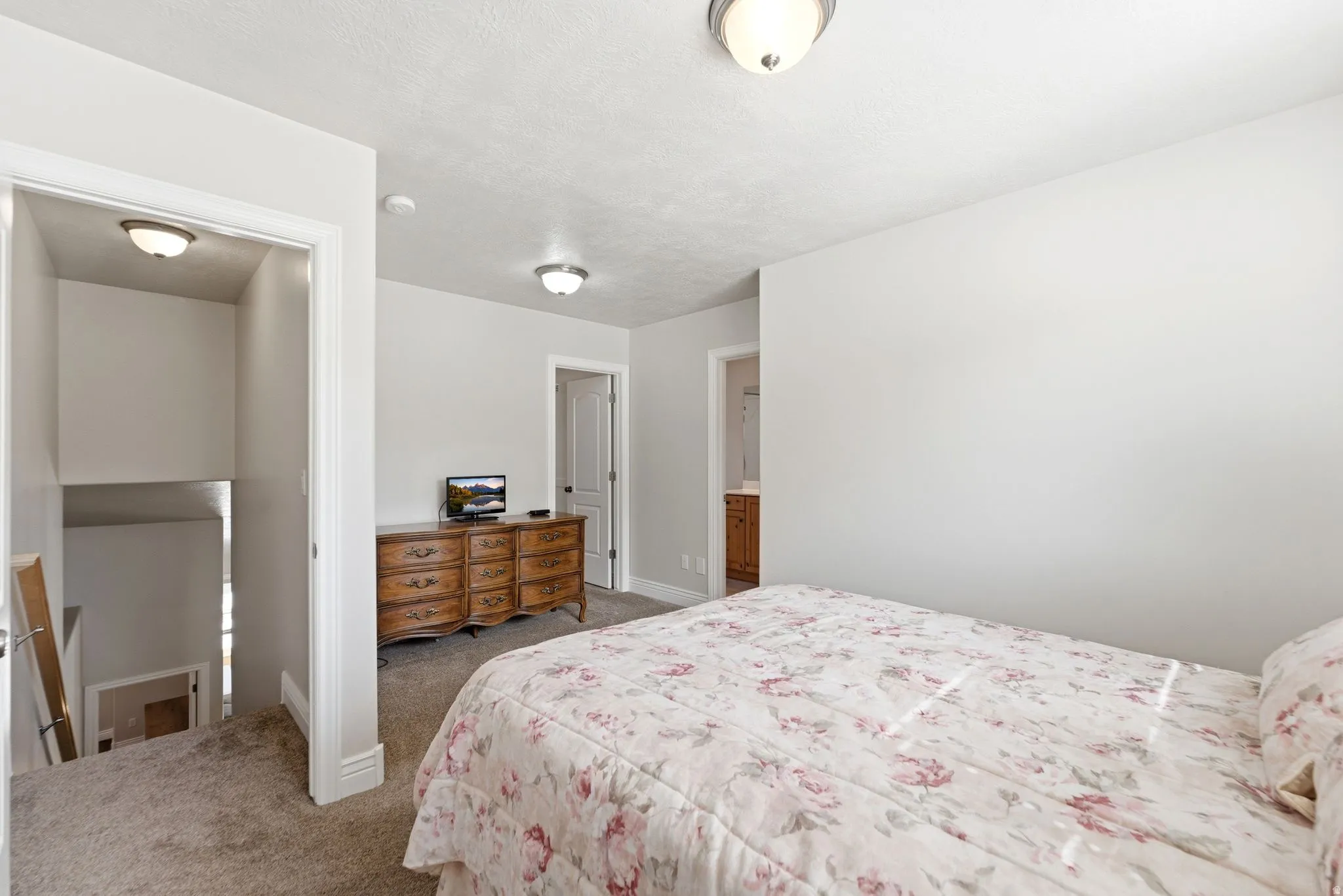 Carpeted bedroom featuring baseboards