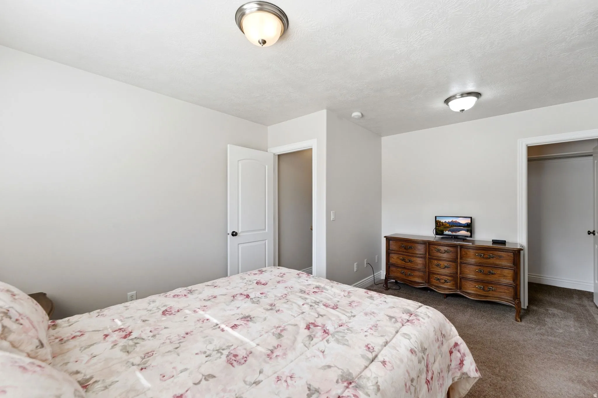 Bedroom featuring dark carpet and a closet