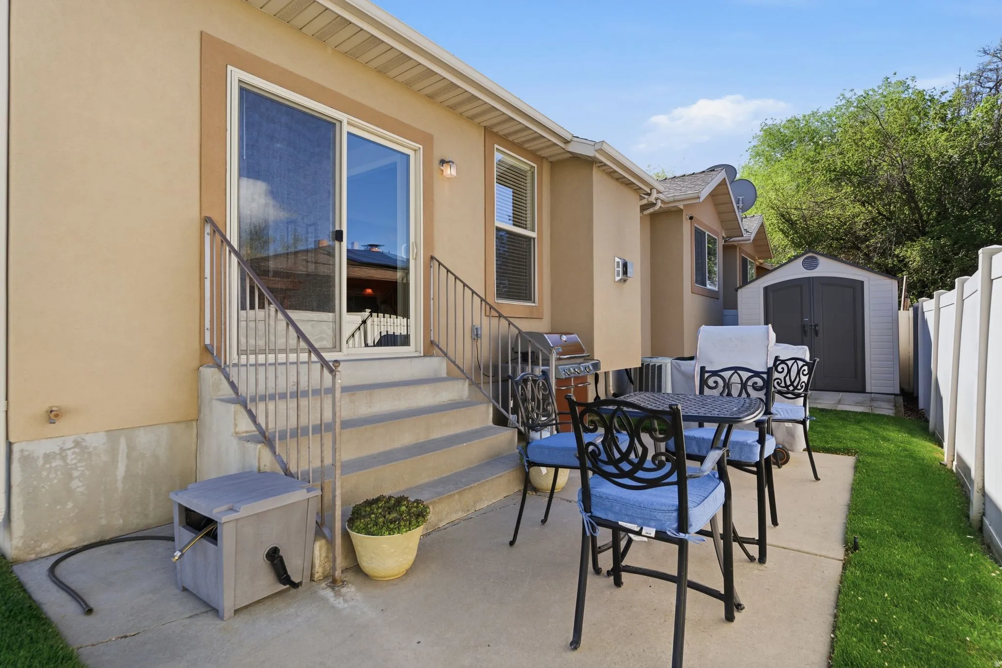 View of patio featuring outdoor dining area, a storage shed, area for grilling, and entry steps