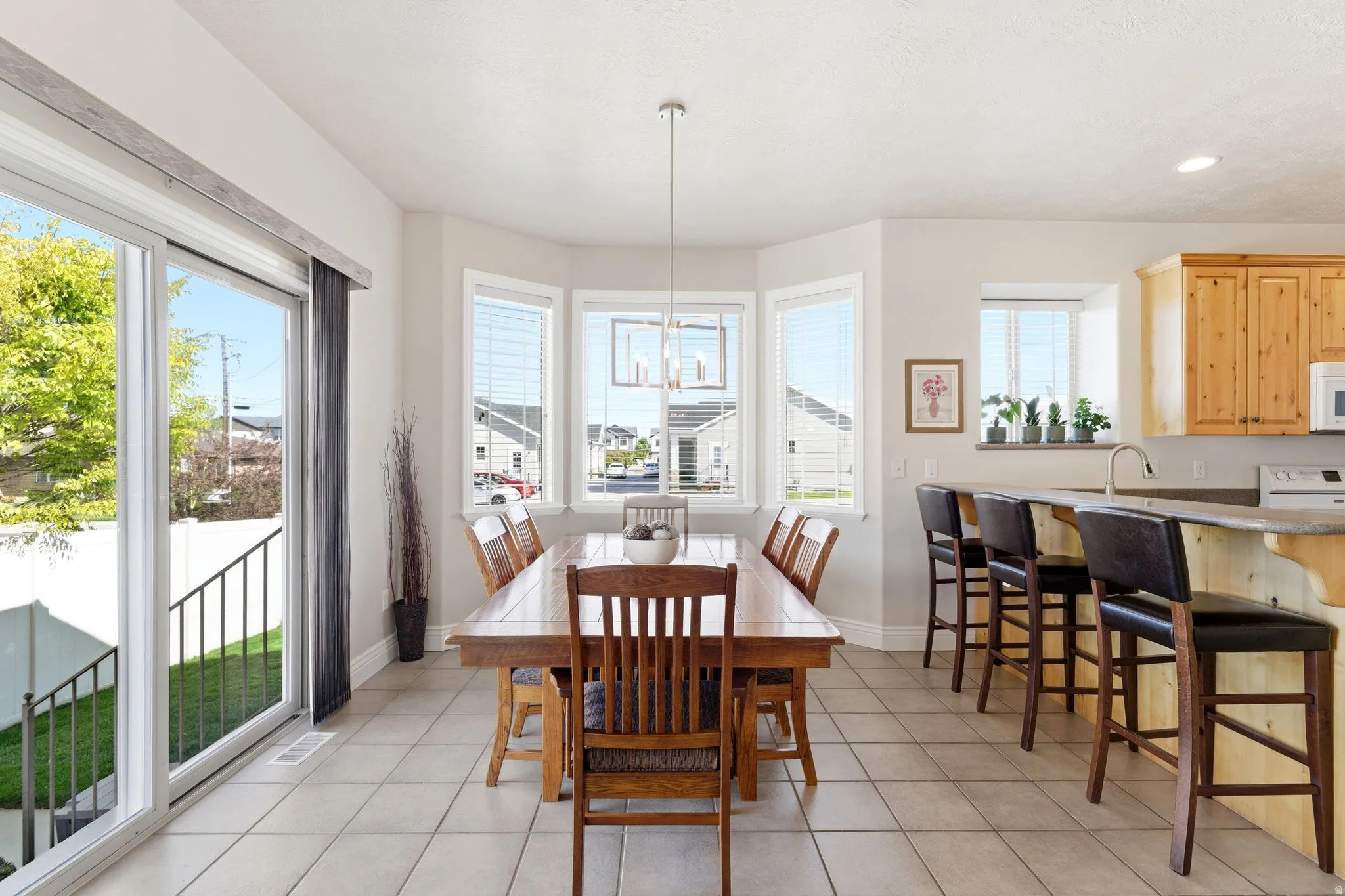 Dining room featuring light tile patterned floors and hanging lights