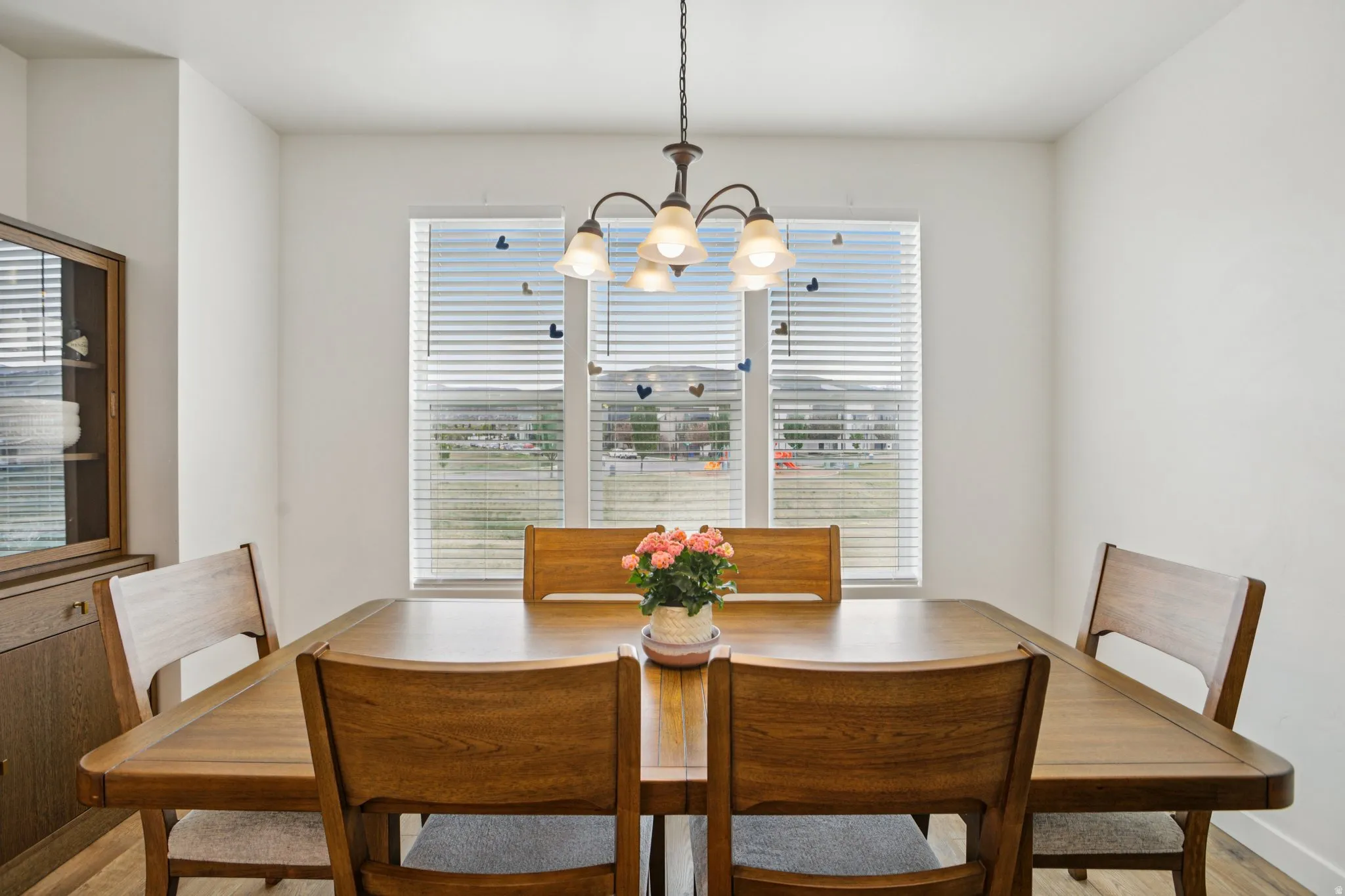 Dining space with hanging lights and light wood finished floors