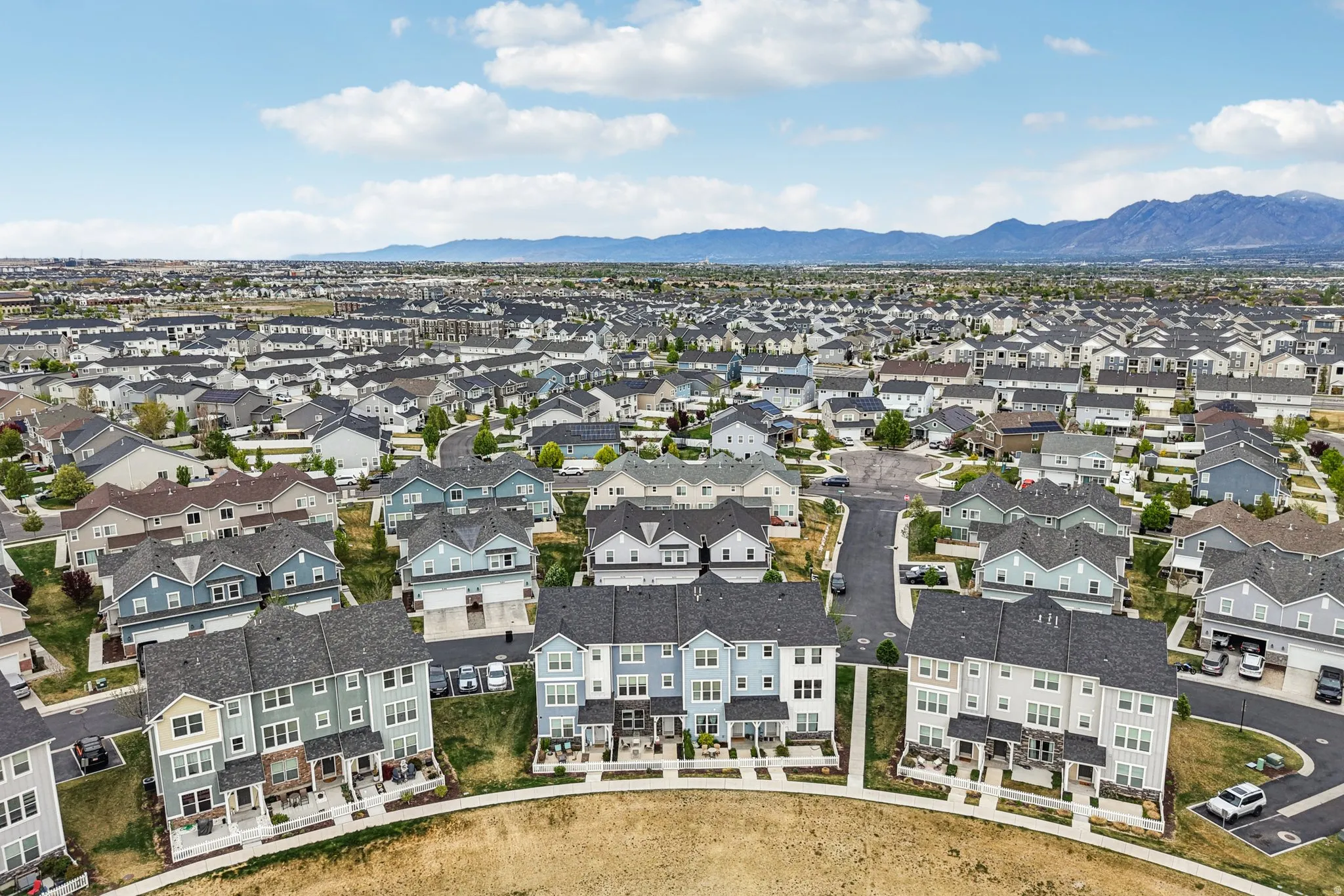 Aerial perspective of suburban area with a mountainous background