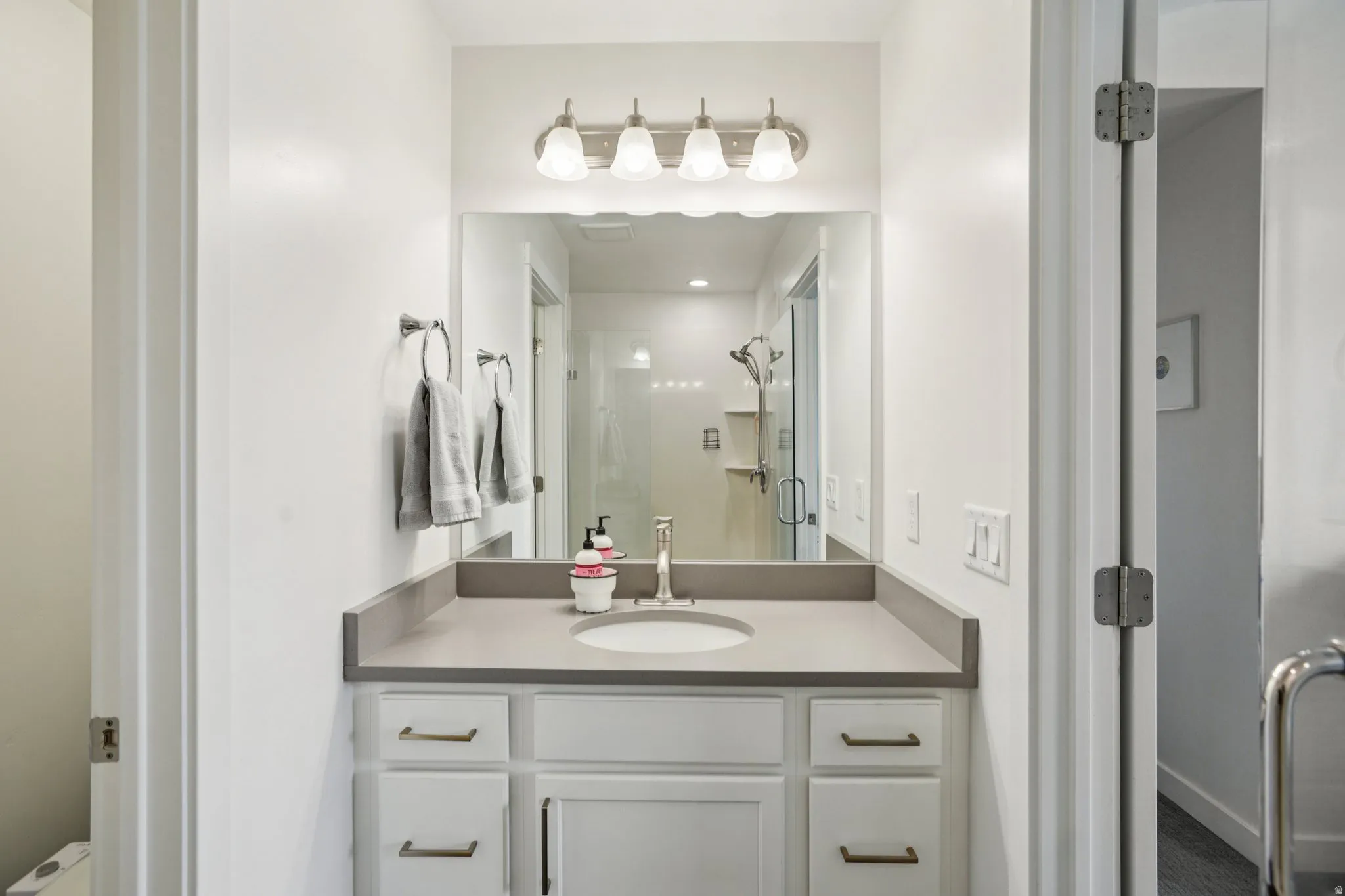 Bathroom with a stall shower and vanity