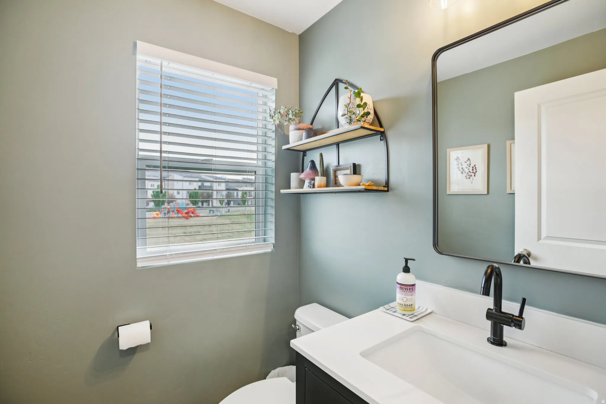 Half bath featuring vanity and toilet