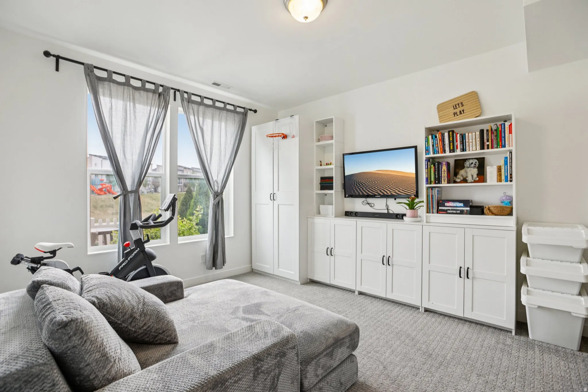 Bedroom with light carpet and baseboards