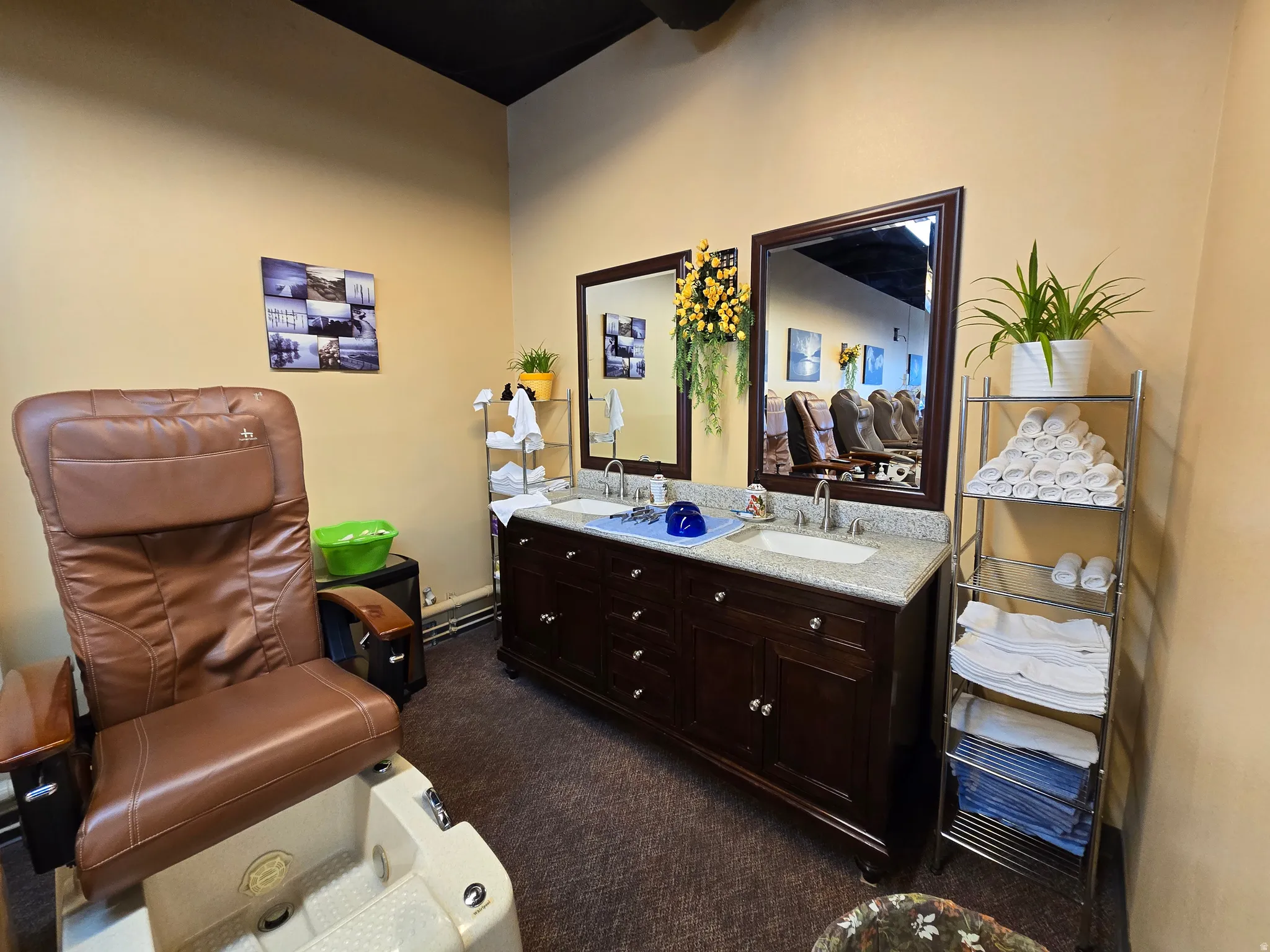 Bathroom with double vanity, dark carpet, and a baseboard radiator
