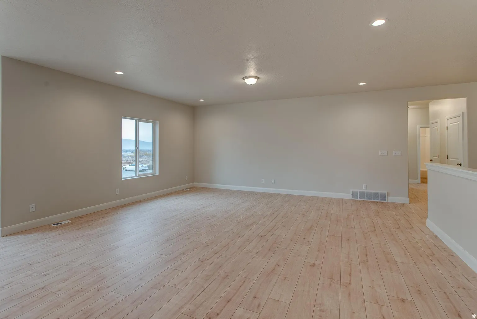 Unfurnished room featuring light wood-style flooring and recessed lighting