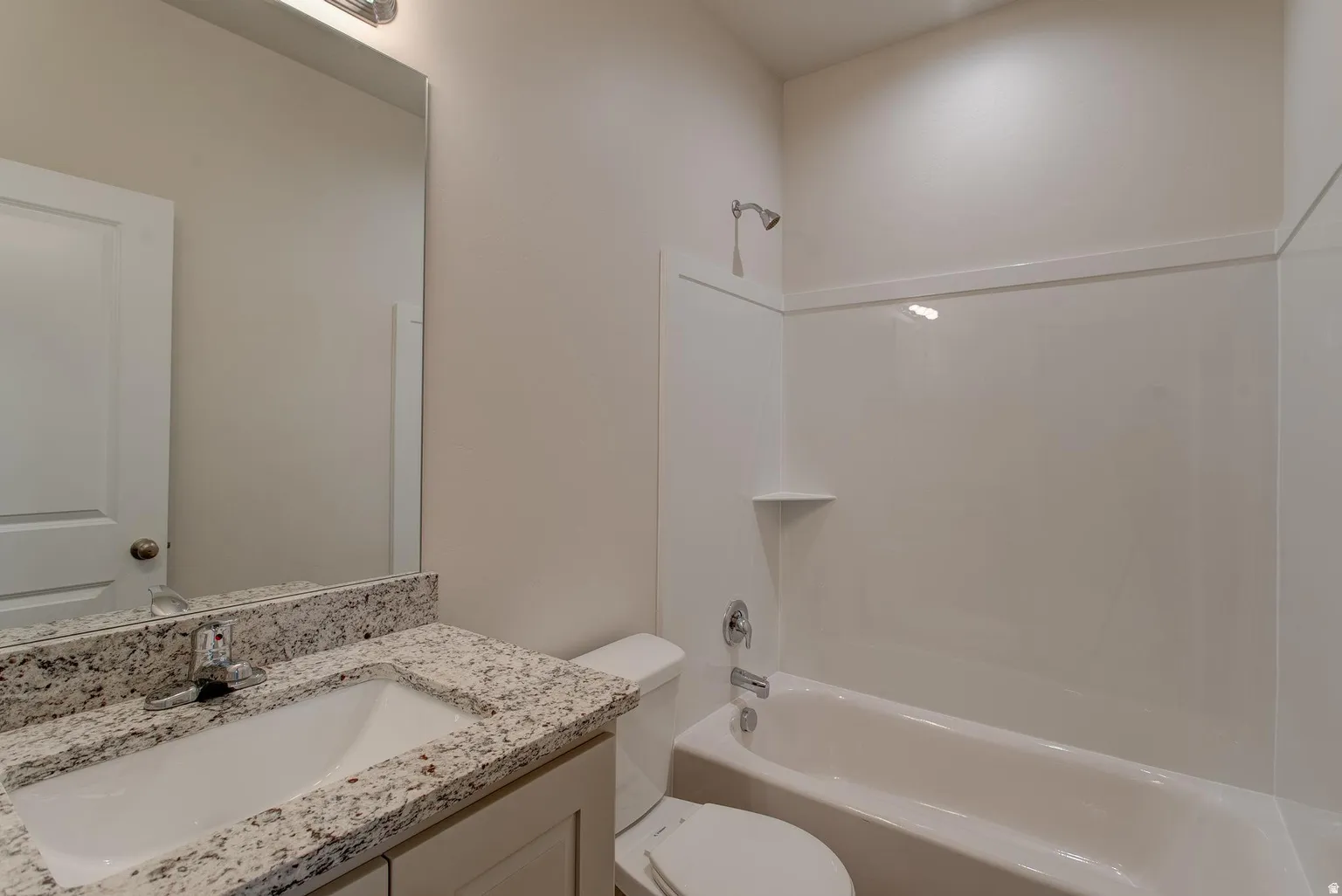 Bathroom featuring vanity and shower / washtub combination