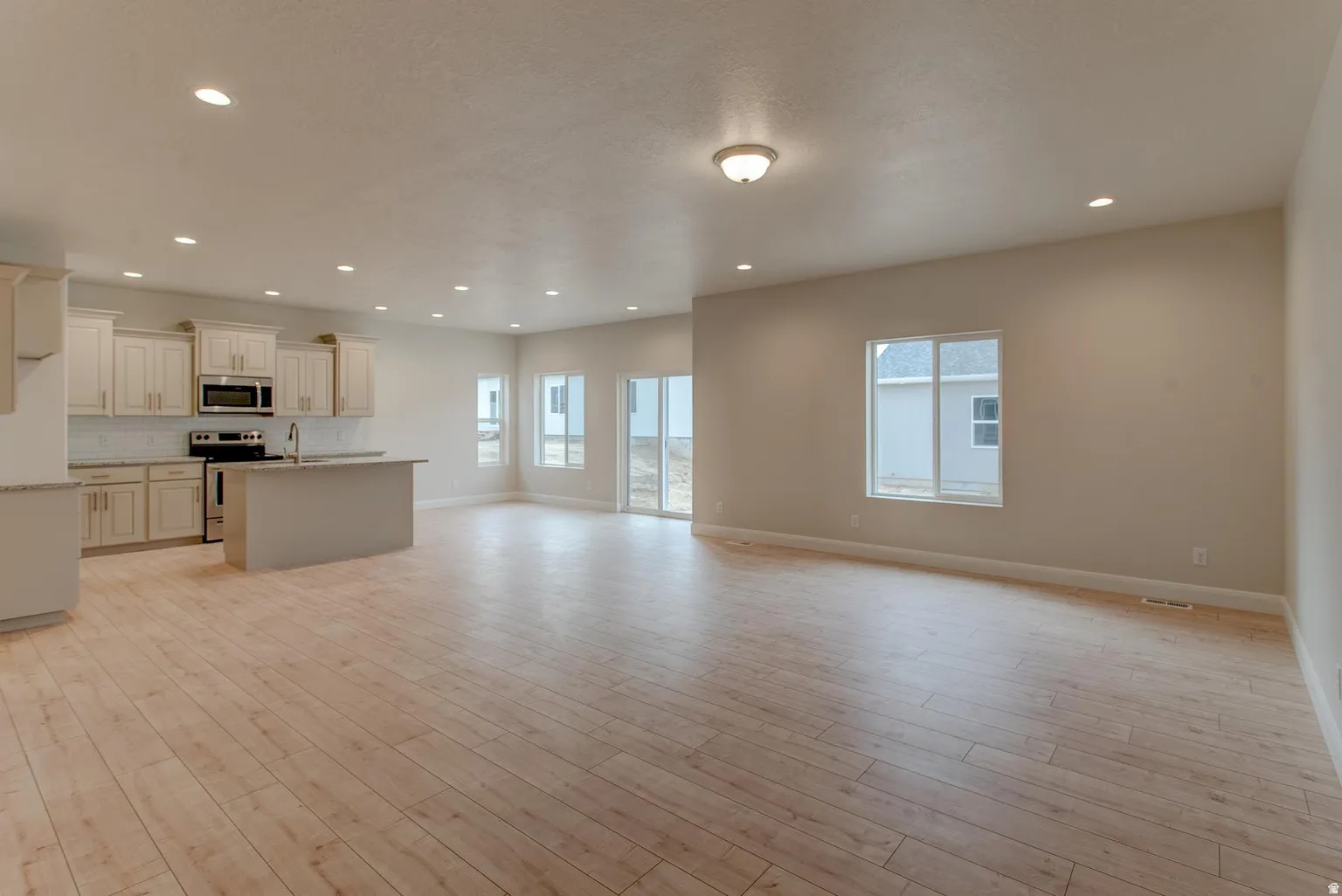 Unfurnished living room with light wood-style floors and recessed lighting