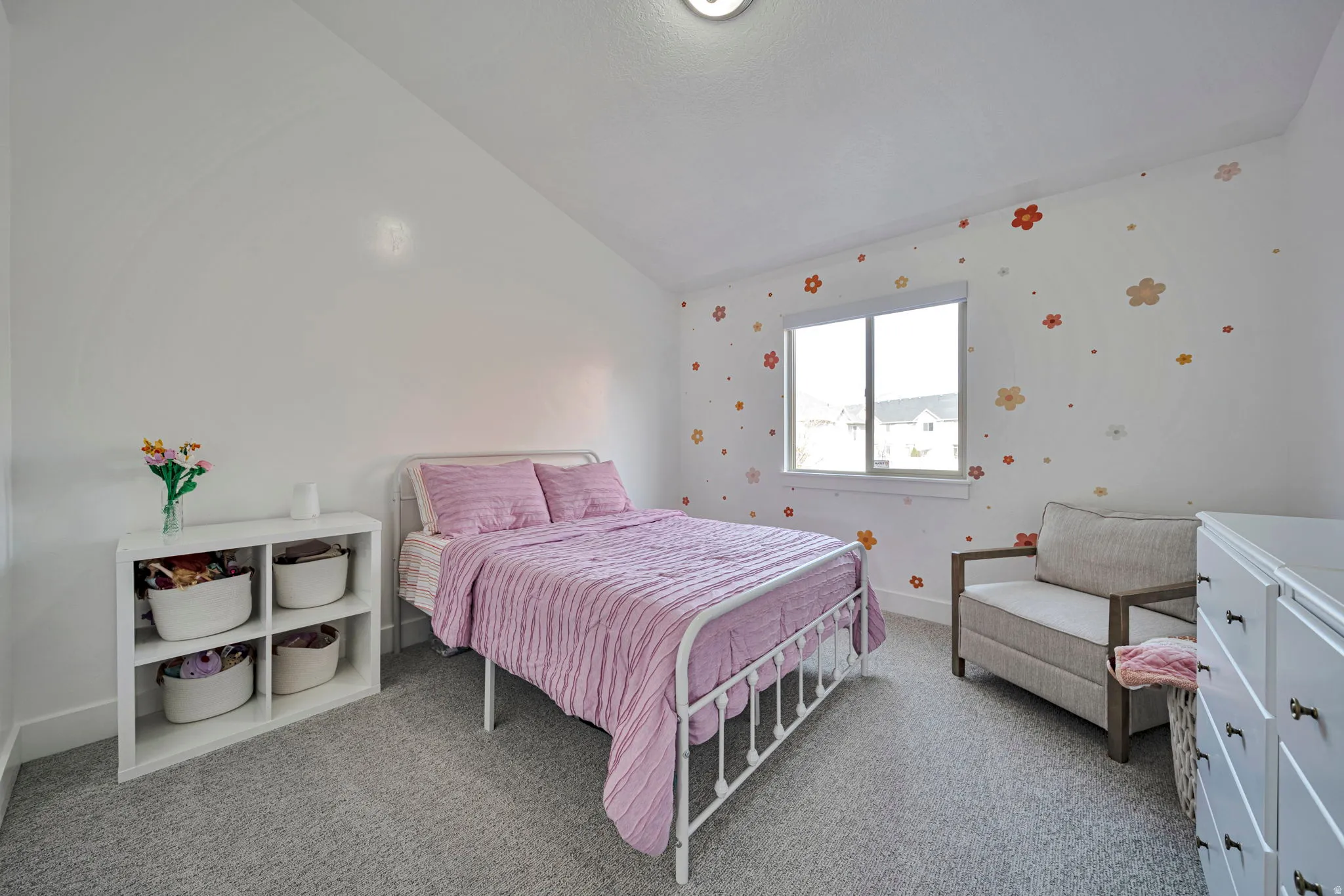 Bedroom featuring lofted ceiling and light colored carpet