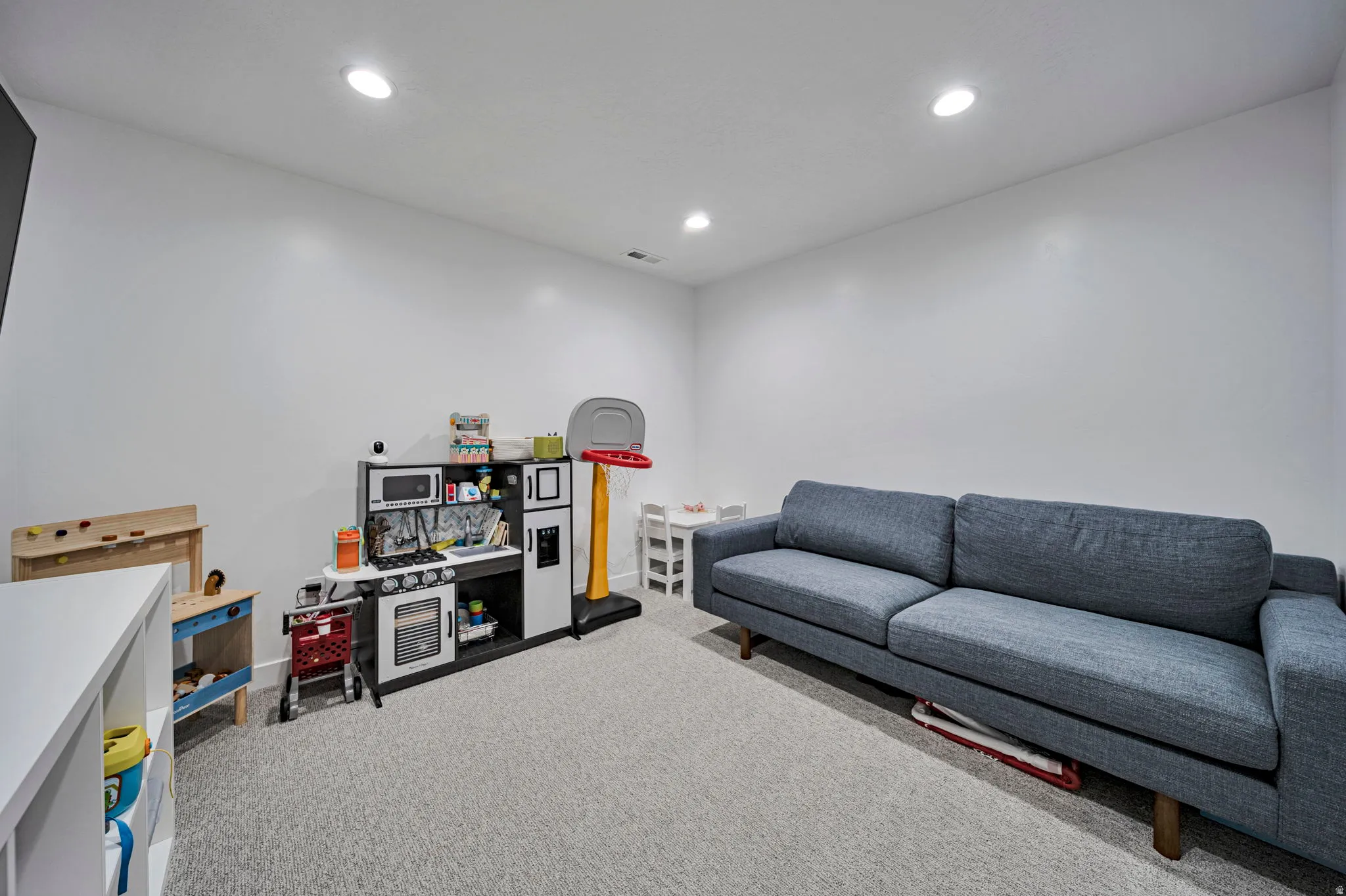Game room with carpet and recessed lighting
