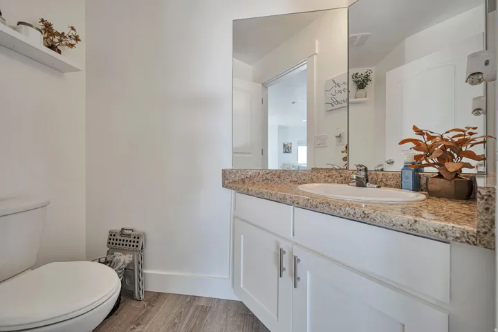 Half bathroom with vanity and light wood finished floors