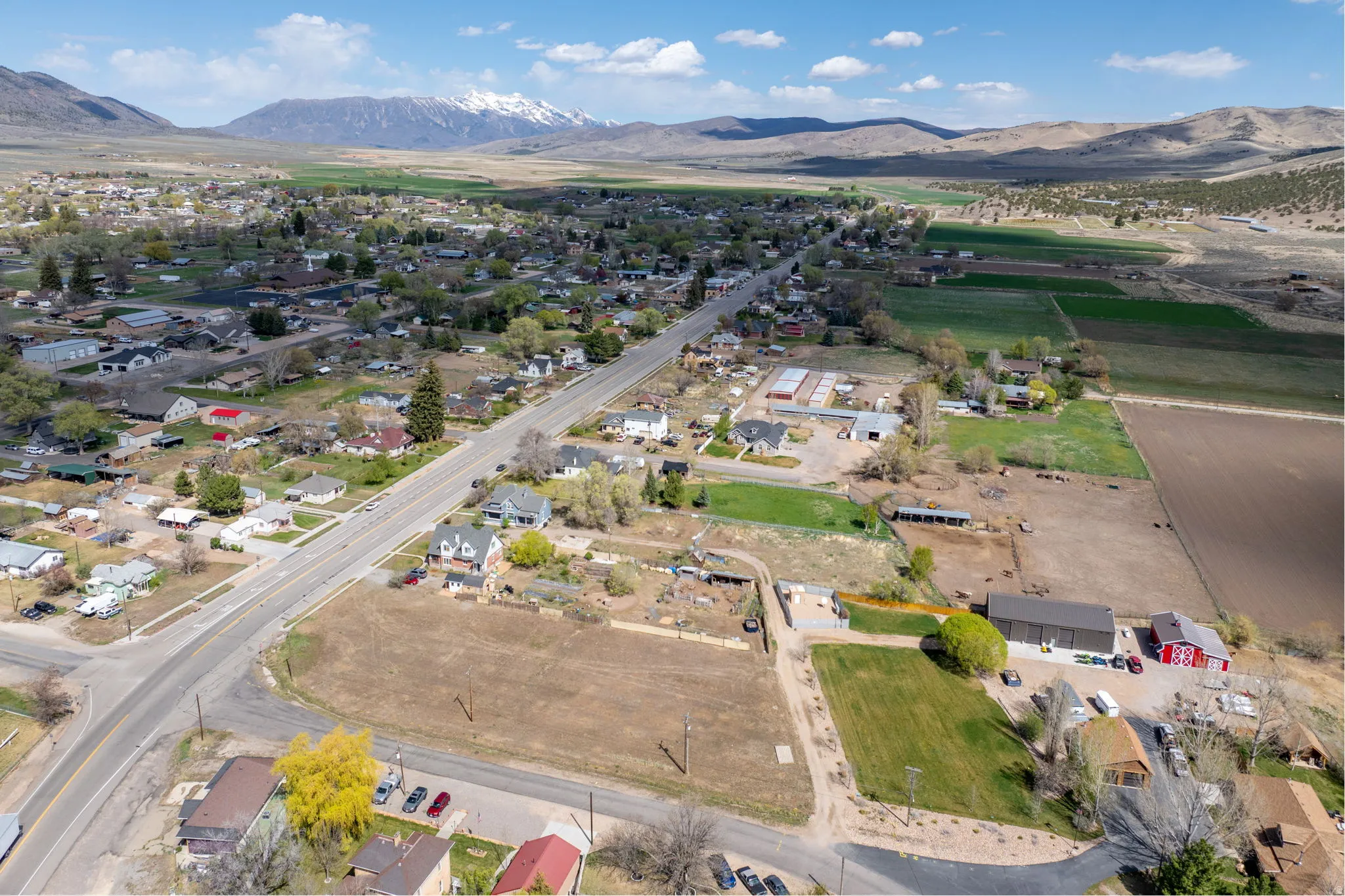 Aerial overview of property's location featuring a mountain backdrop and rural landscape