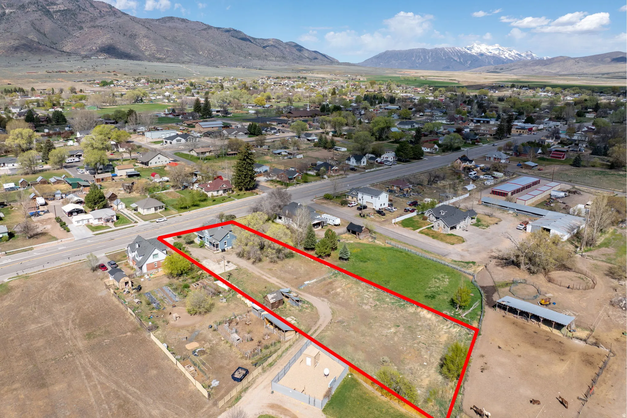 Aerial perspective of suburban area featuring mountains and property boundaries highlighted