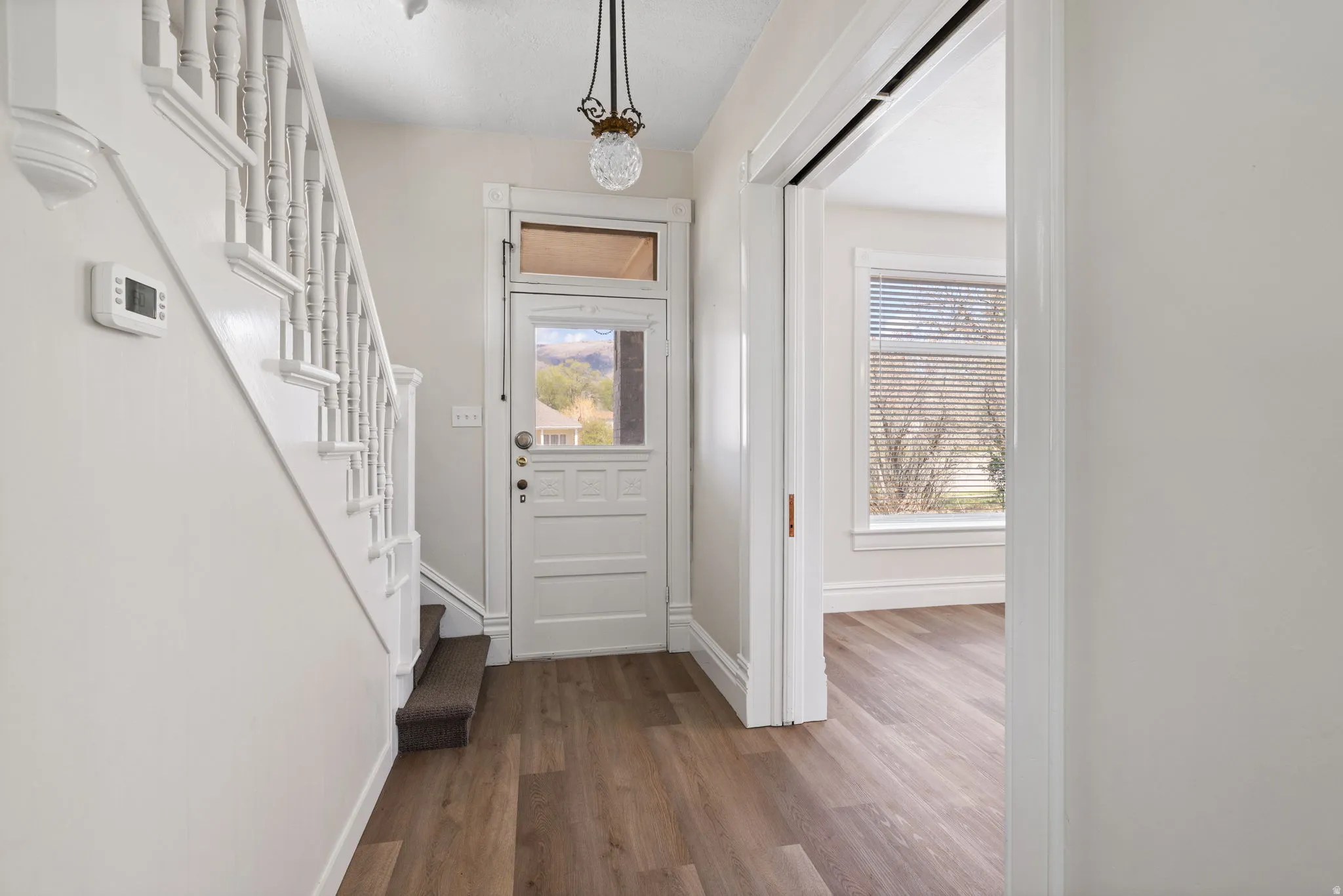 Foyer entrance with dark wood-style flooring and healthy amount of natural light