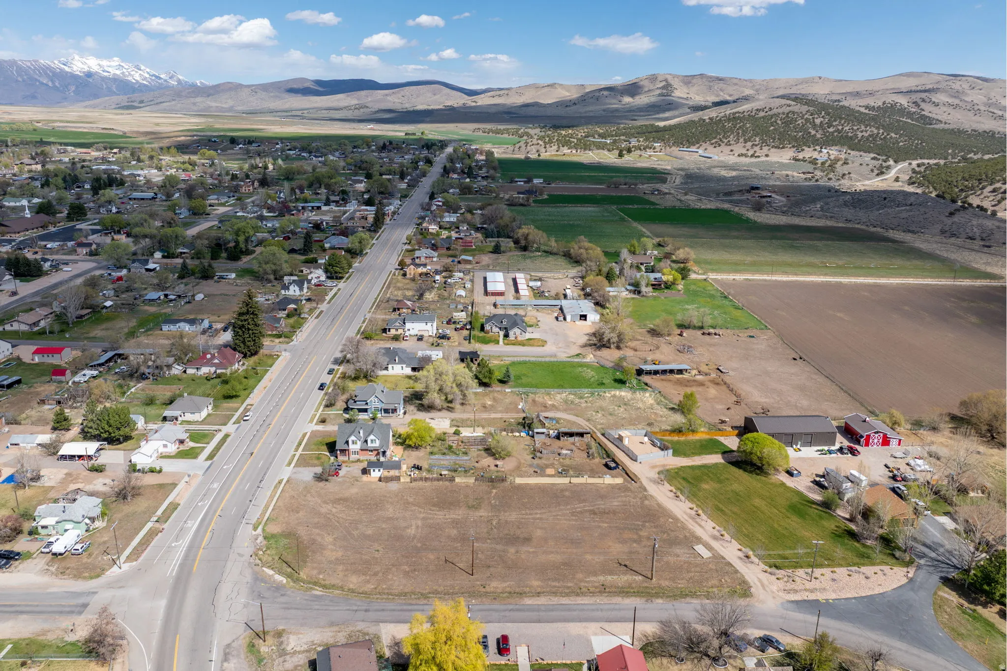Aerial overview of property's location with a mountain backdrop and rural landscape