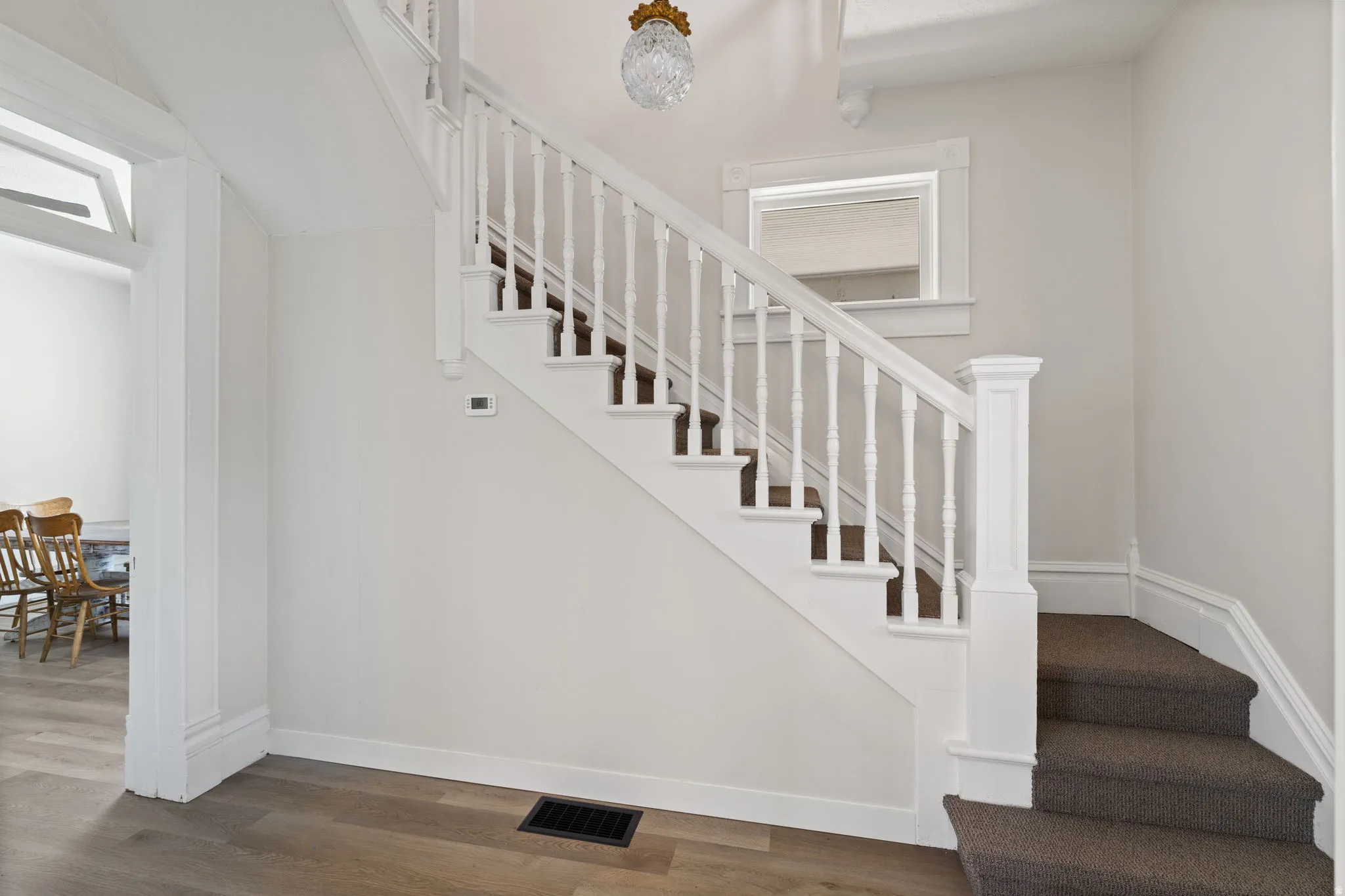Stairway featuring baseboards and wood finished floors