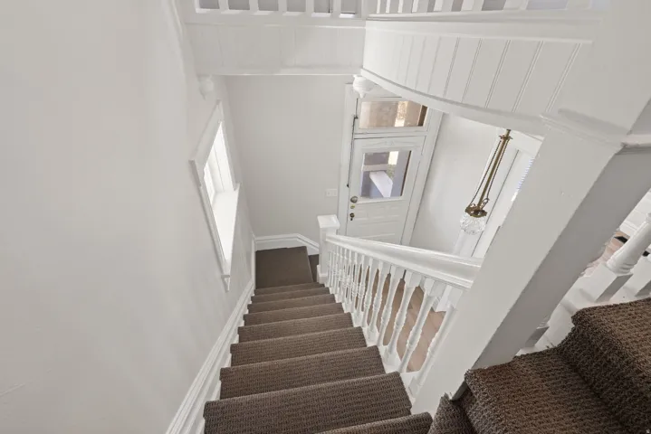 Stairs with carpet and baseboards