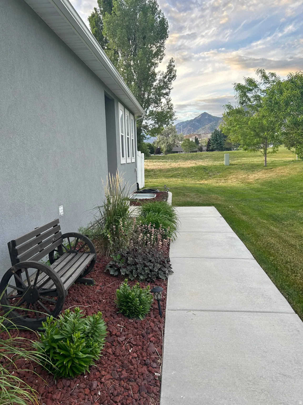 Yard at dusk featuring a yard and a mountain view