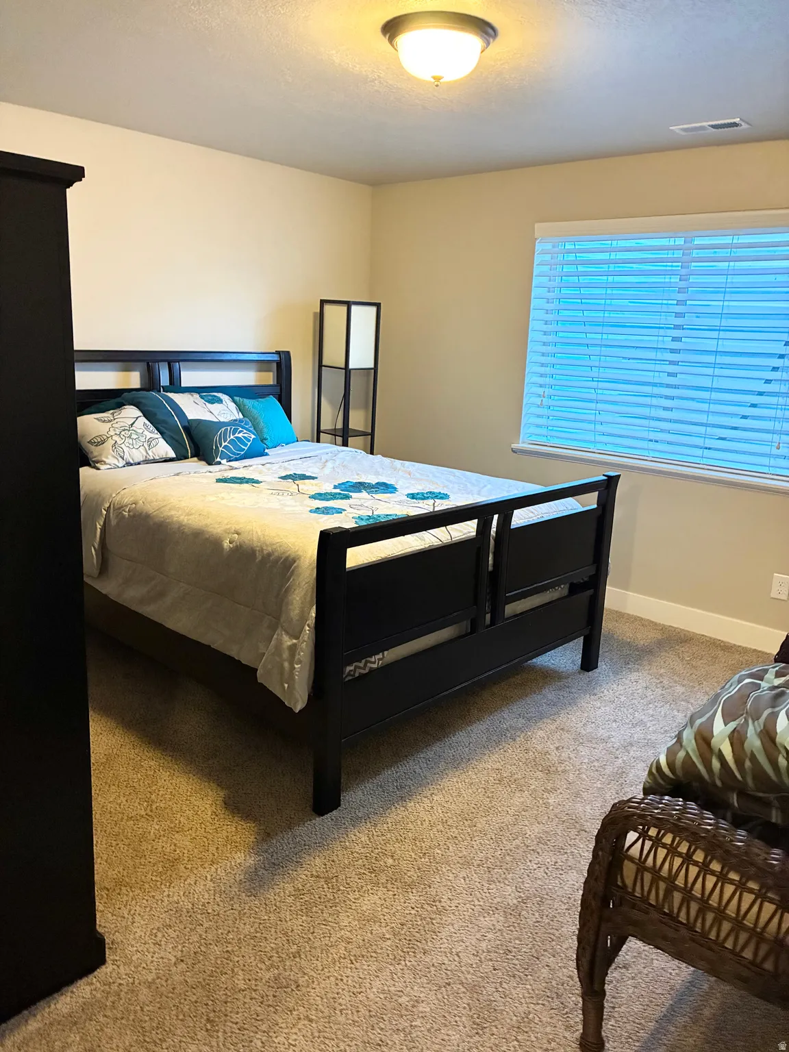 Bedroom featuring baseboards and light carpet