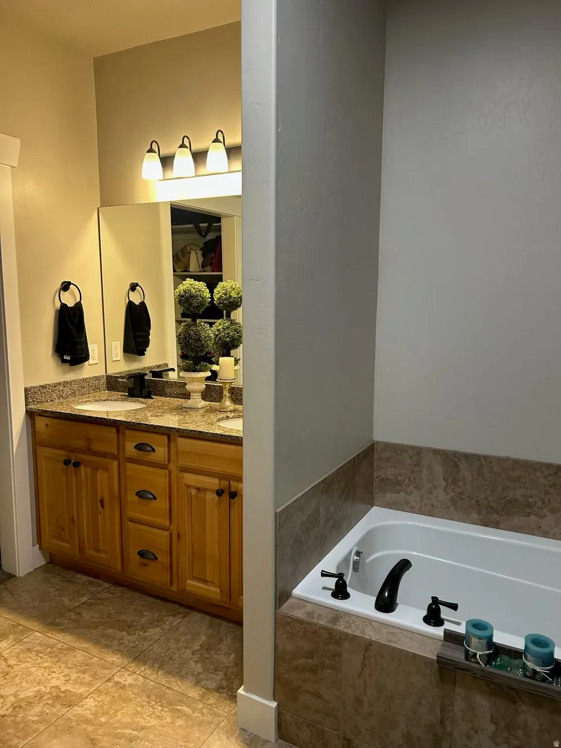 Bathroom with double vanity and a garden tub