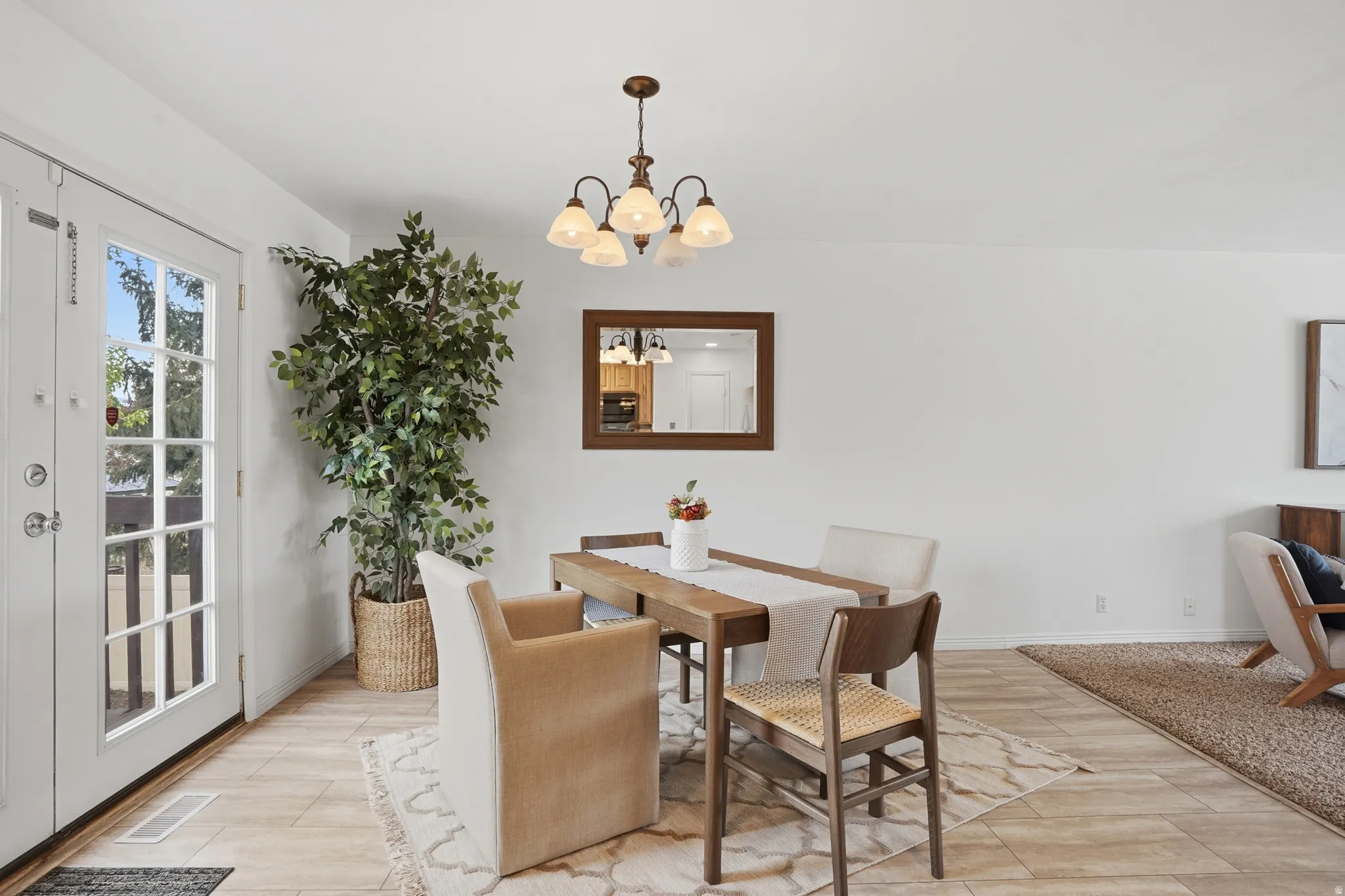 Dining room with suspended lighting and light wood-type flooring