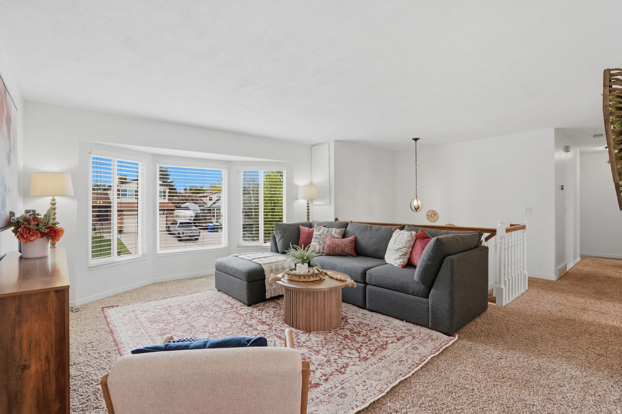 Living room with light colored carpet and baseboards