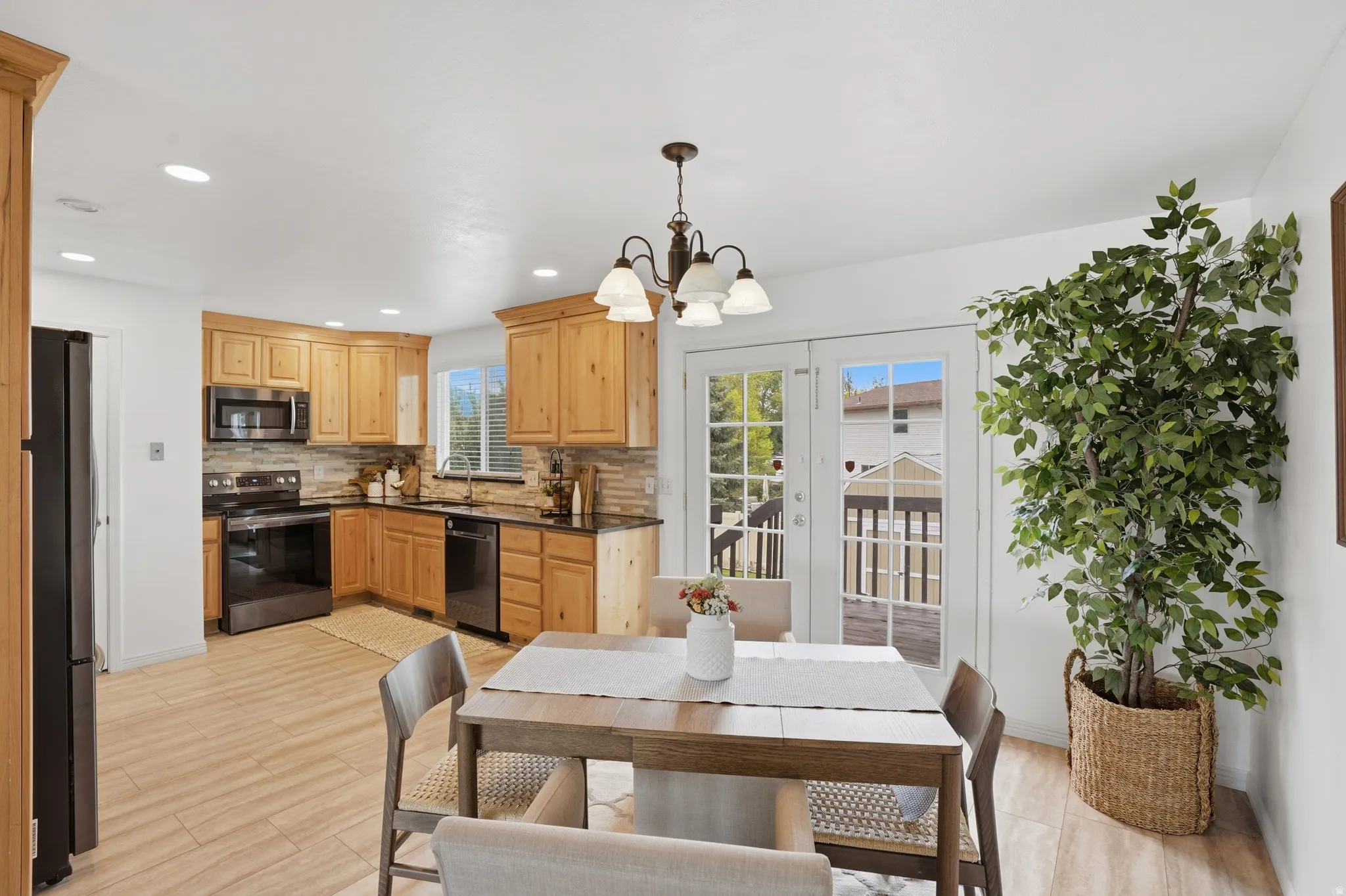 Dining area featuring hanging lights and light wood finished floors