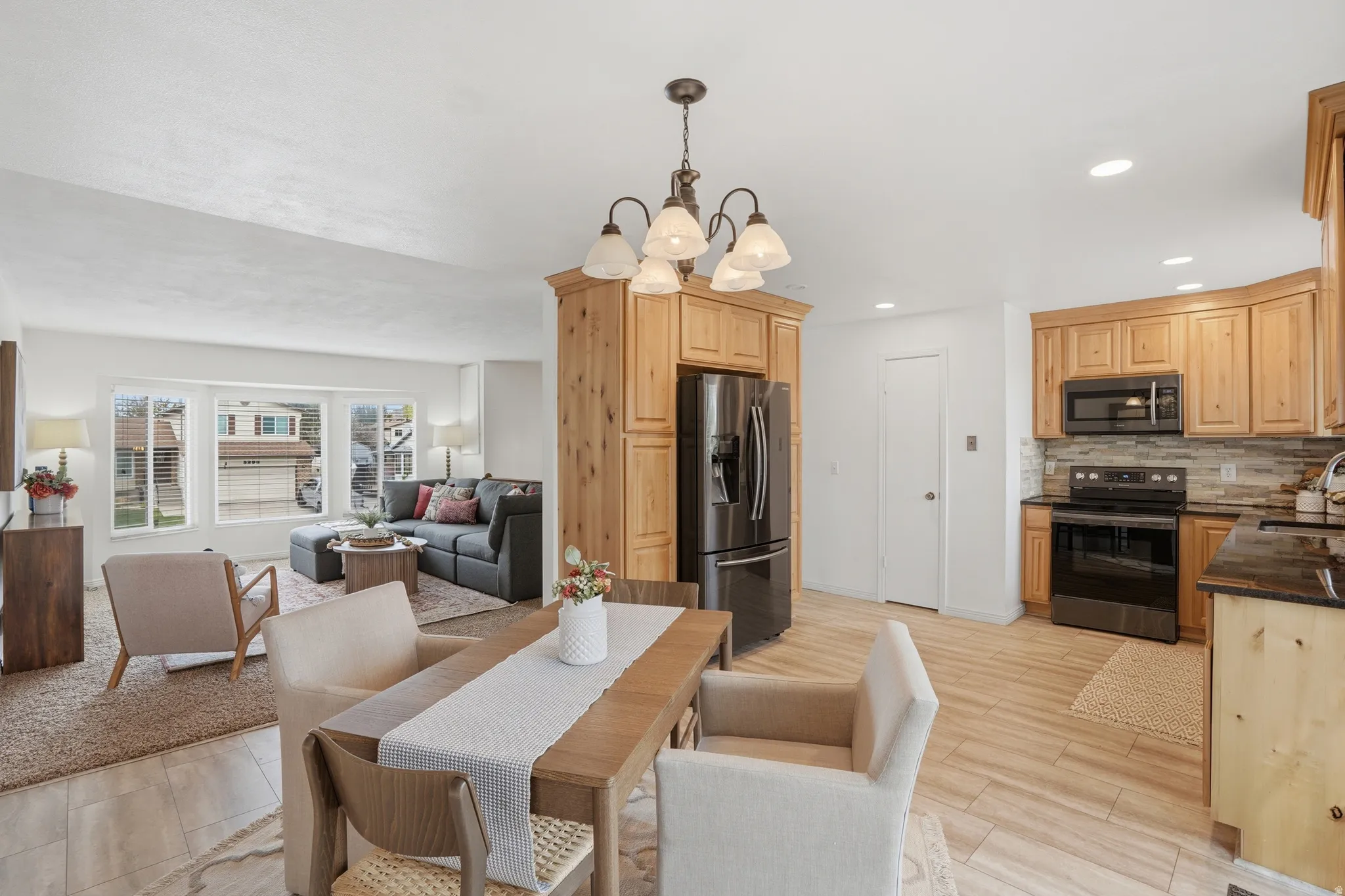 Dining space with hanging lights and wood tiled floors