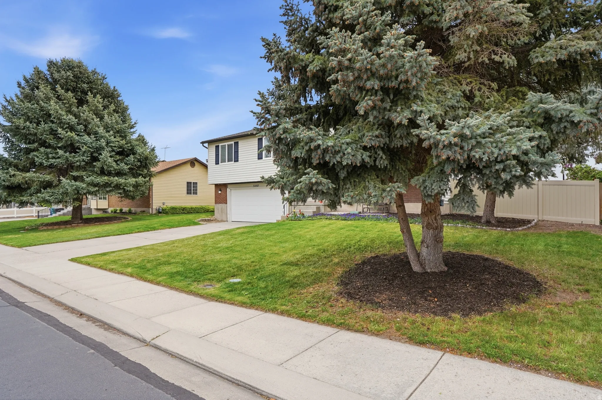 View of front of property featuring a garage and concrete driveway