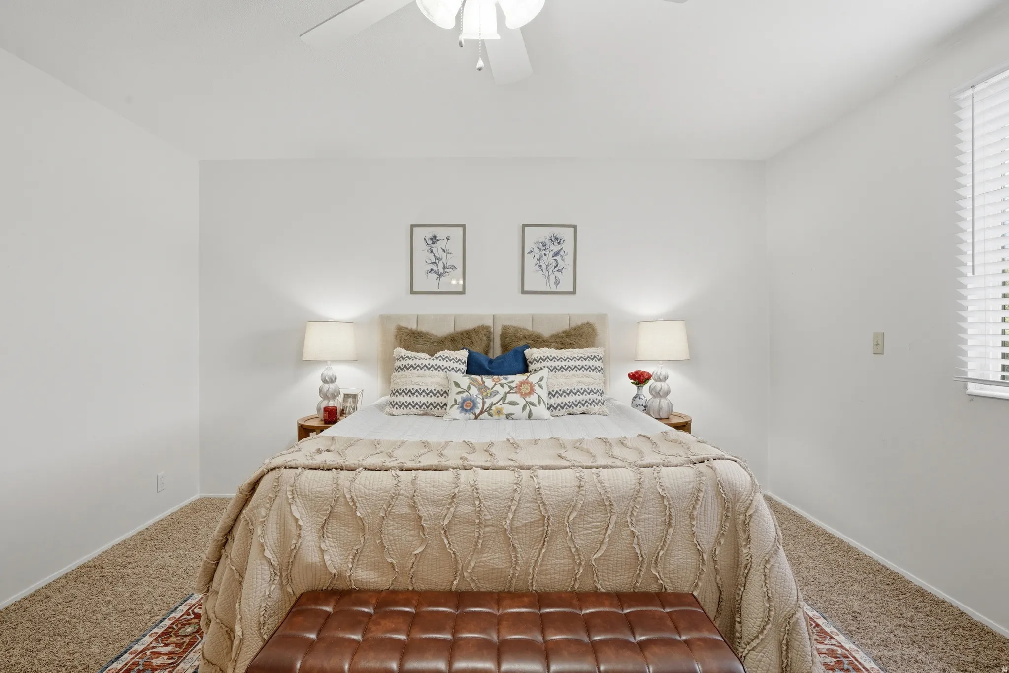 Carpeted bedroom featuring ceiling fan and baseboards