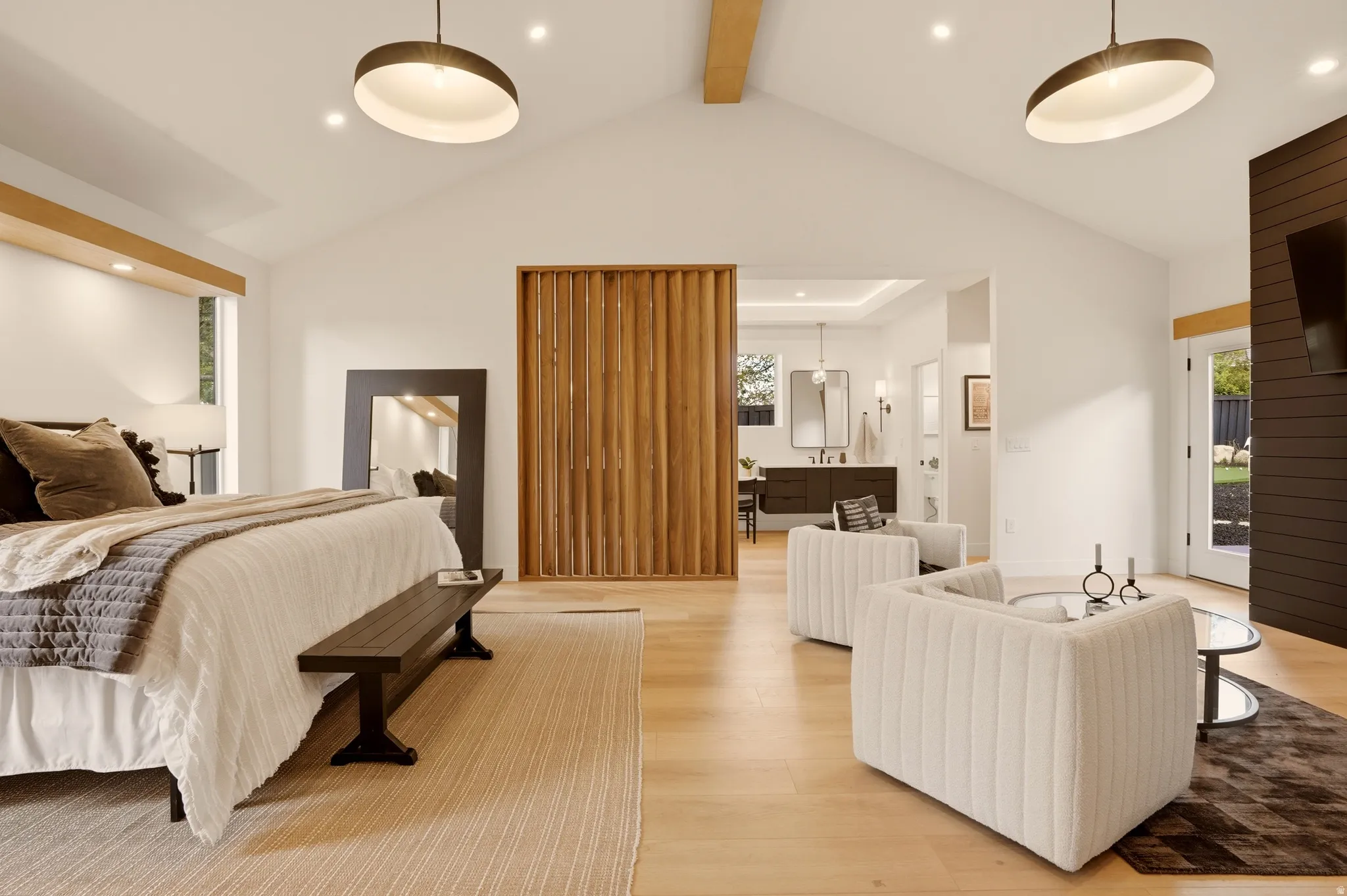 MAIN FLOOR PRIMARY BEDROOM SUITE WITH ANGLED PRIVACY WALNUT WALL