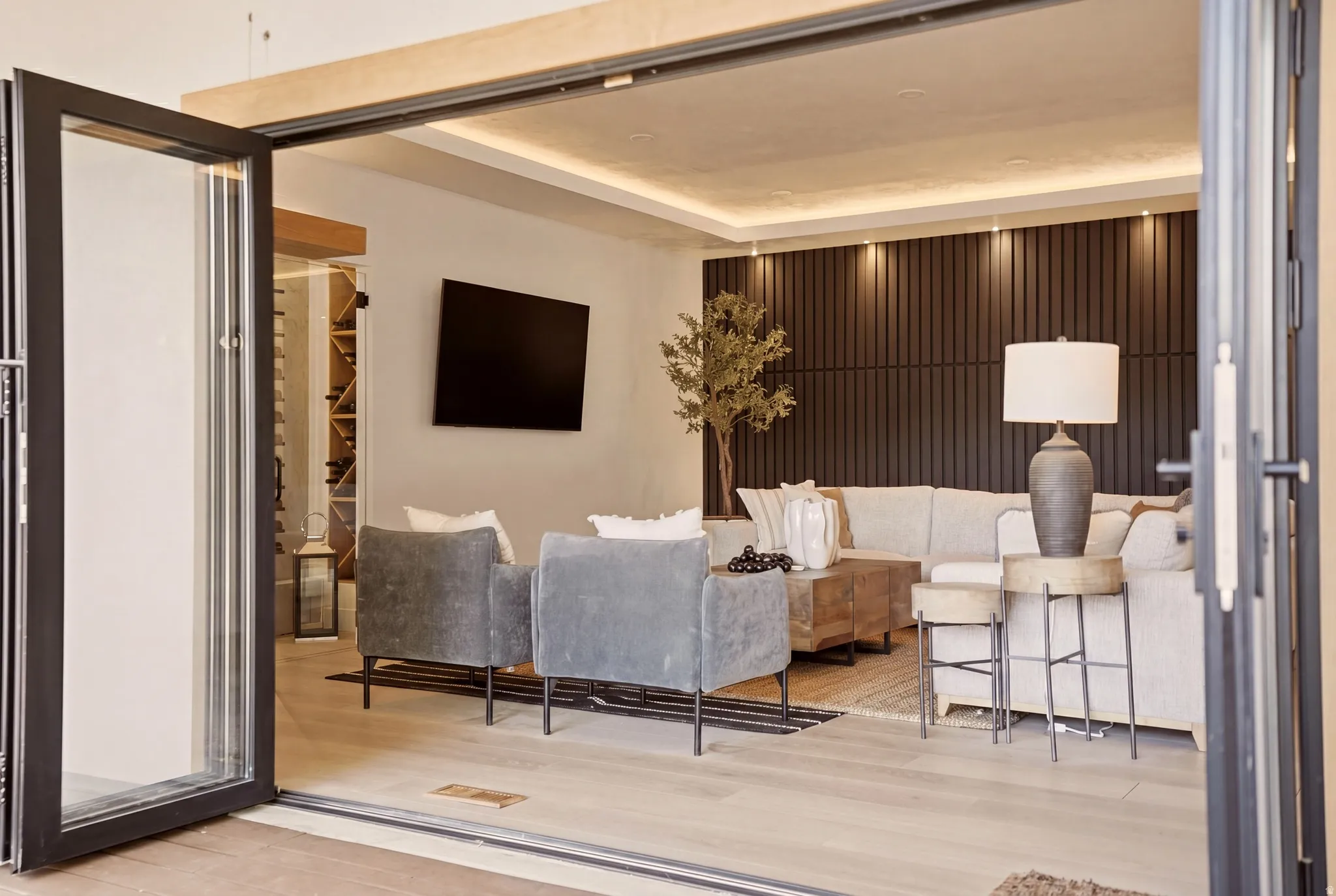 FAMILY ROOM WITH WINE ROOM AND EXPANSIVE FOLDING PATIO DOOR