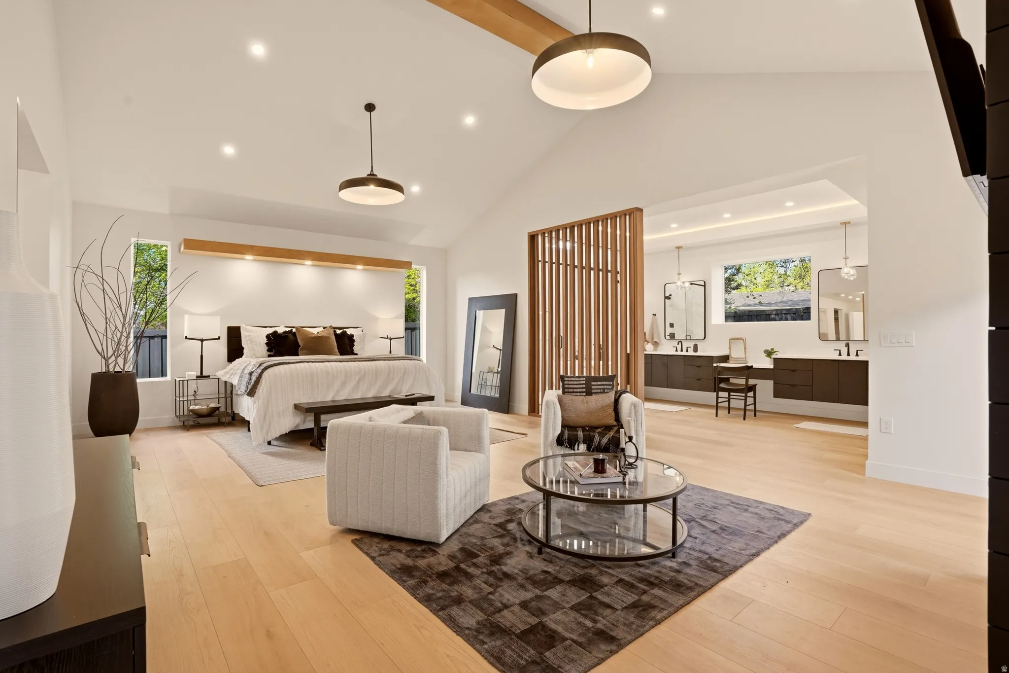 MAIN FLOOR PRIMARY BEDROOM SUITE WITH ANGLED PRIVACY WALNUT WALL