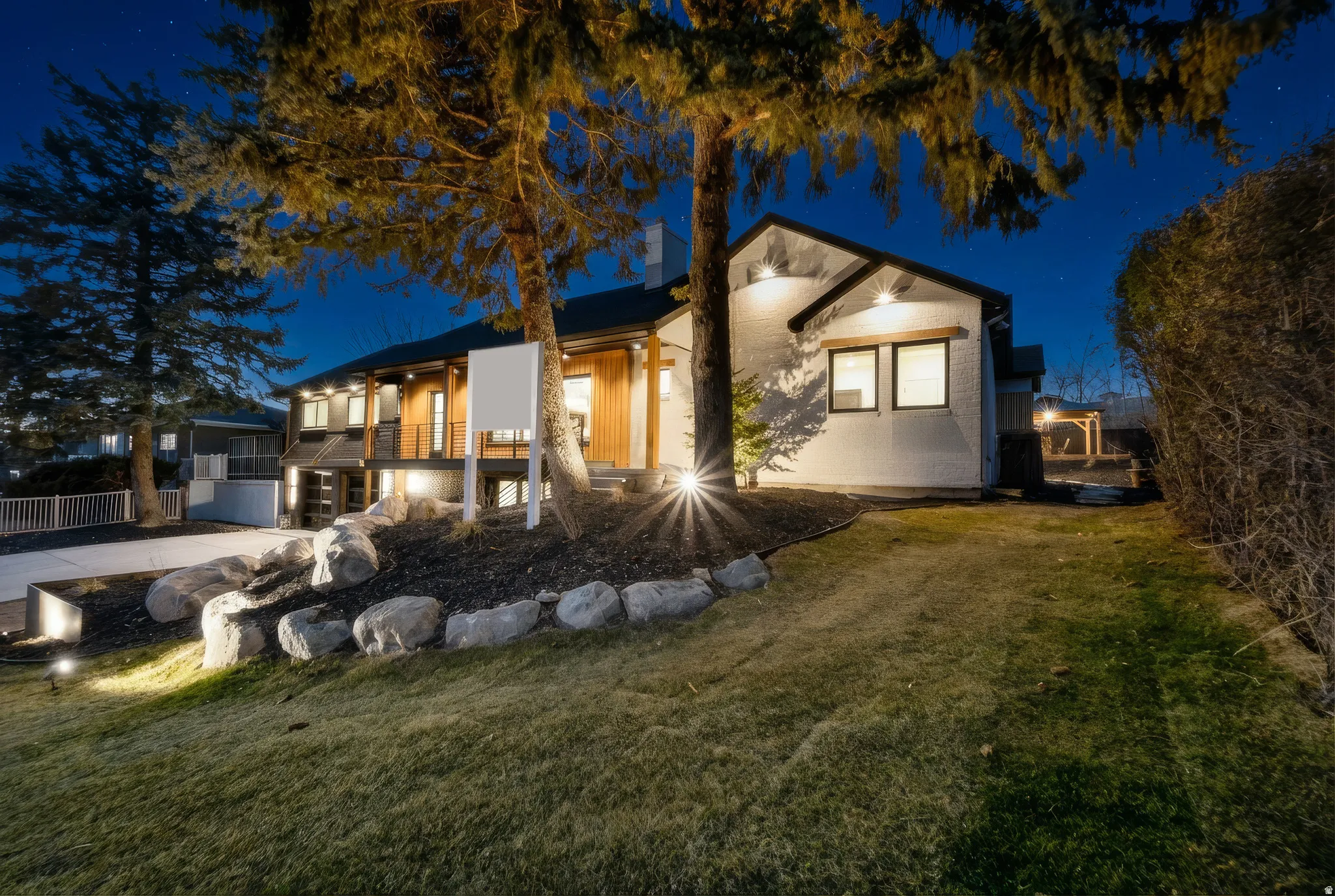 Modern exterior with white siding and dark trim
