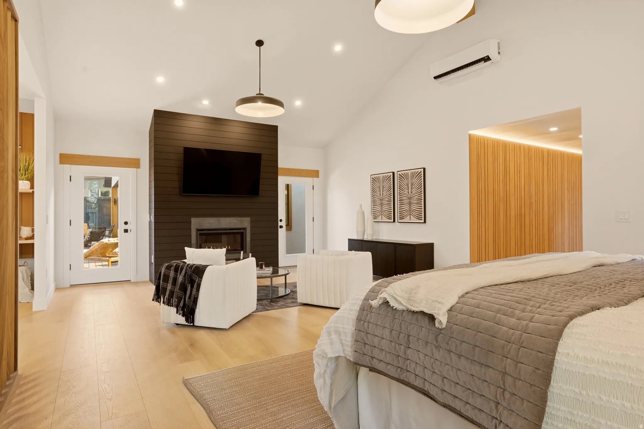 MAIN FLOOR PRIMARY BEDROOM SUITE WITH GAS FIREPLACE AND OPENS ONTO BACK YARD