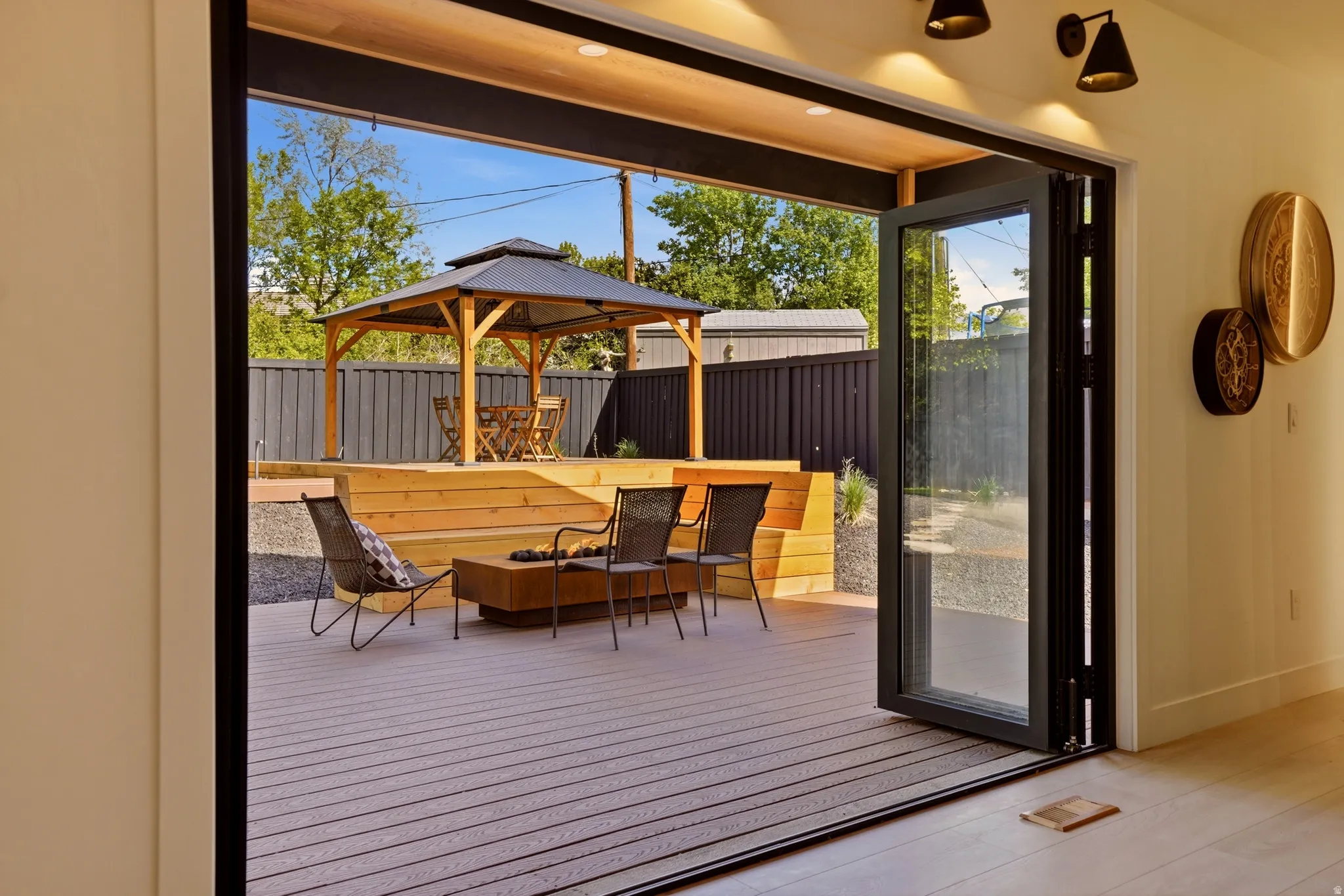 Deck featuring a gazebo and a fenced backyard