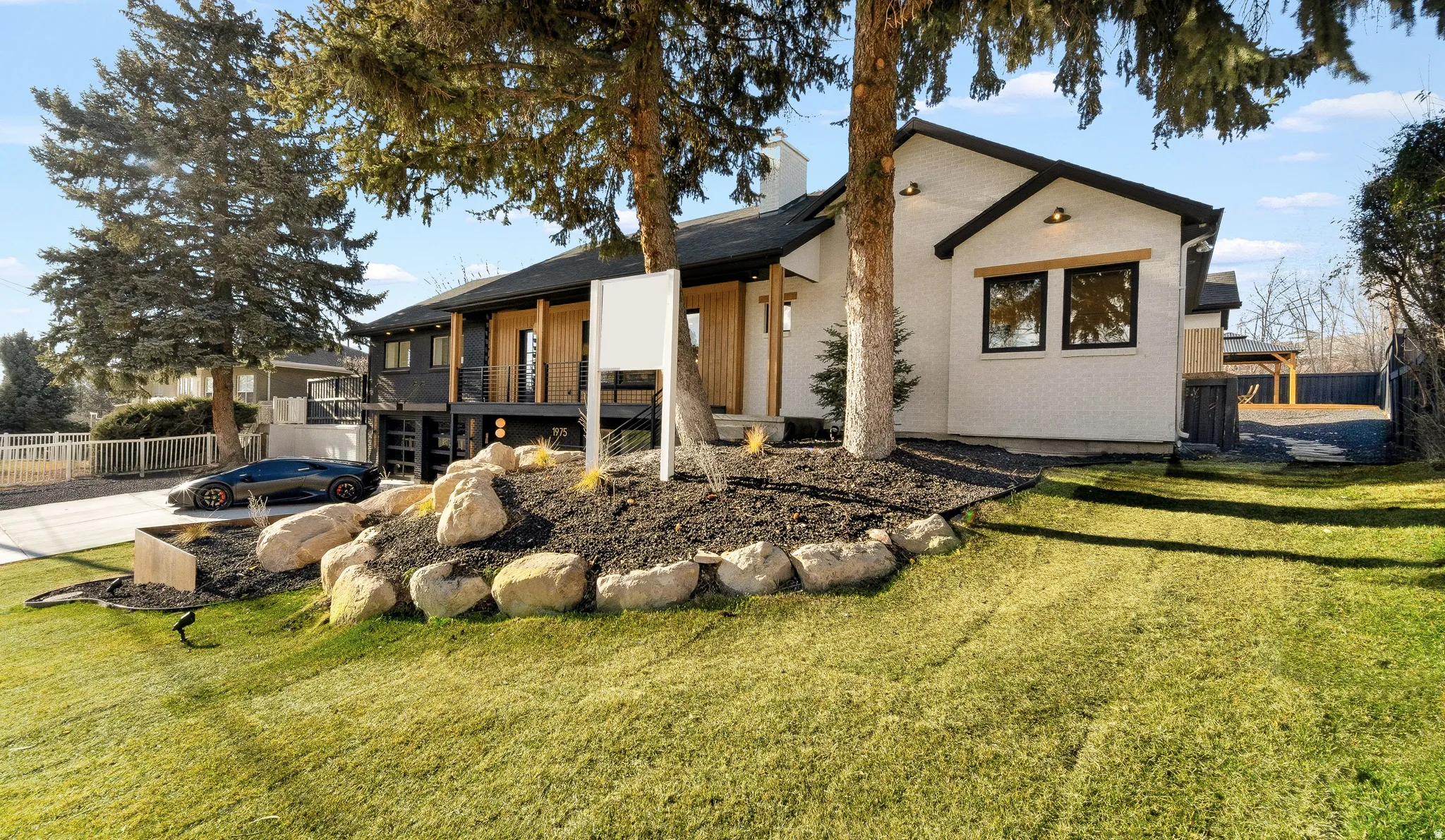 Modern exterior featuring white brick and dark trim accents