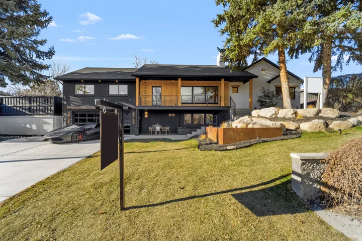 Contemporary exterior featuring a black facade and wood-paneled accents