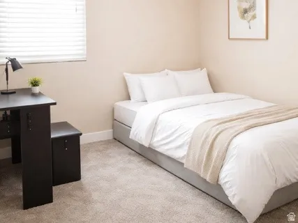 Carpeted bedroom with baseboards