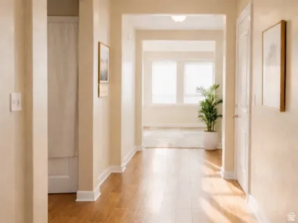 Hall featuring light wood finished floors and baseboards