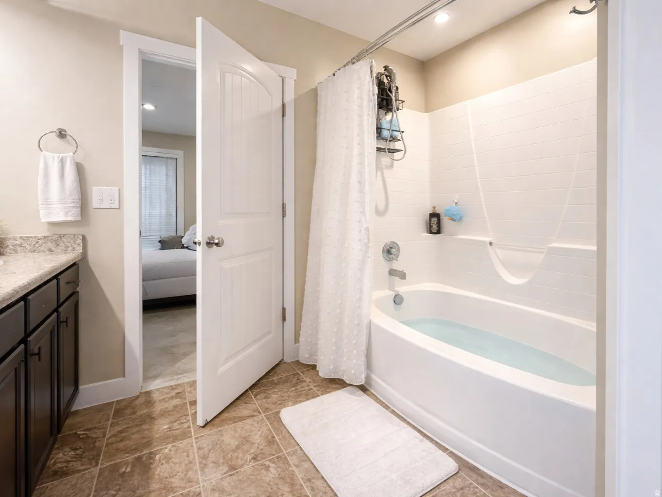 Ensuite bathroom with vanity, shower / bath combo with shower curtain, and recessed lighting