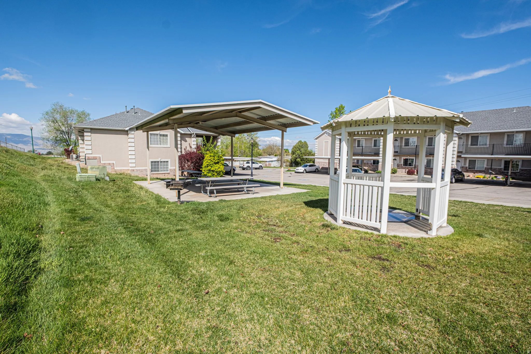Rear view of property with a patio area, a gazebo, and a lawn