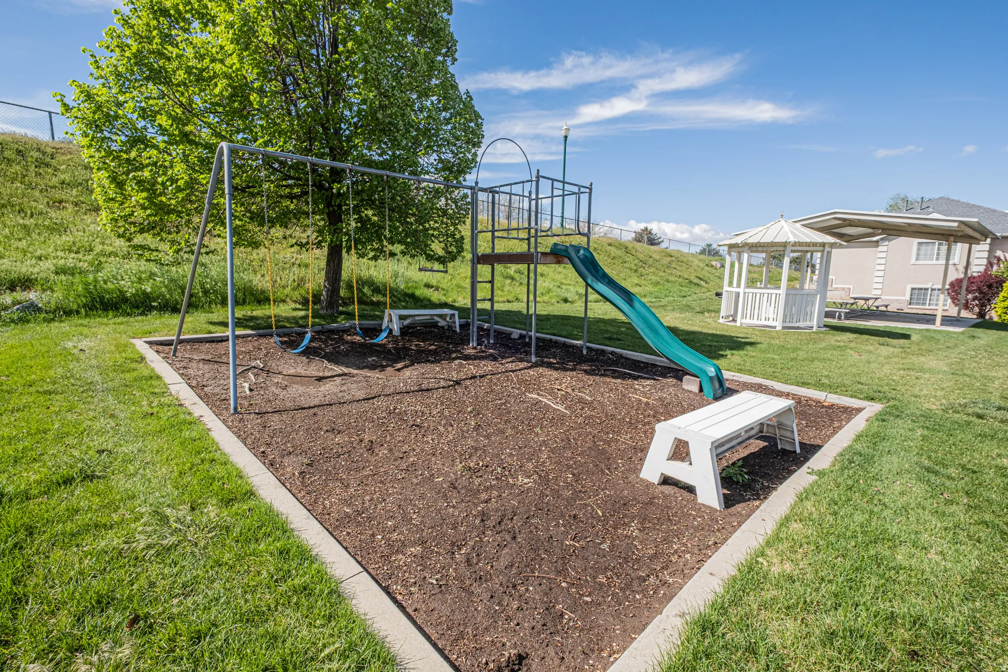 Community jungle gym with a gazebo and a yard