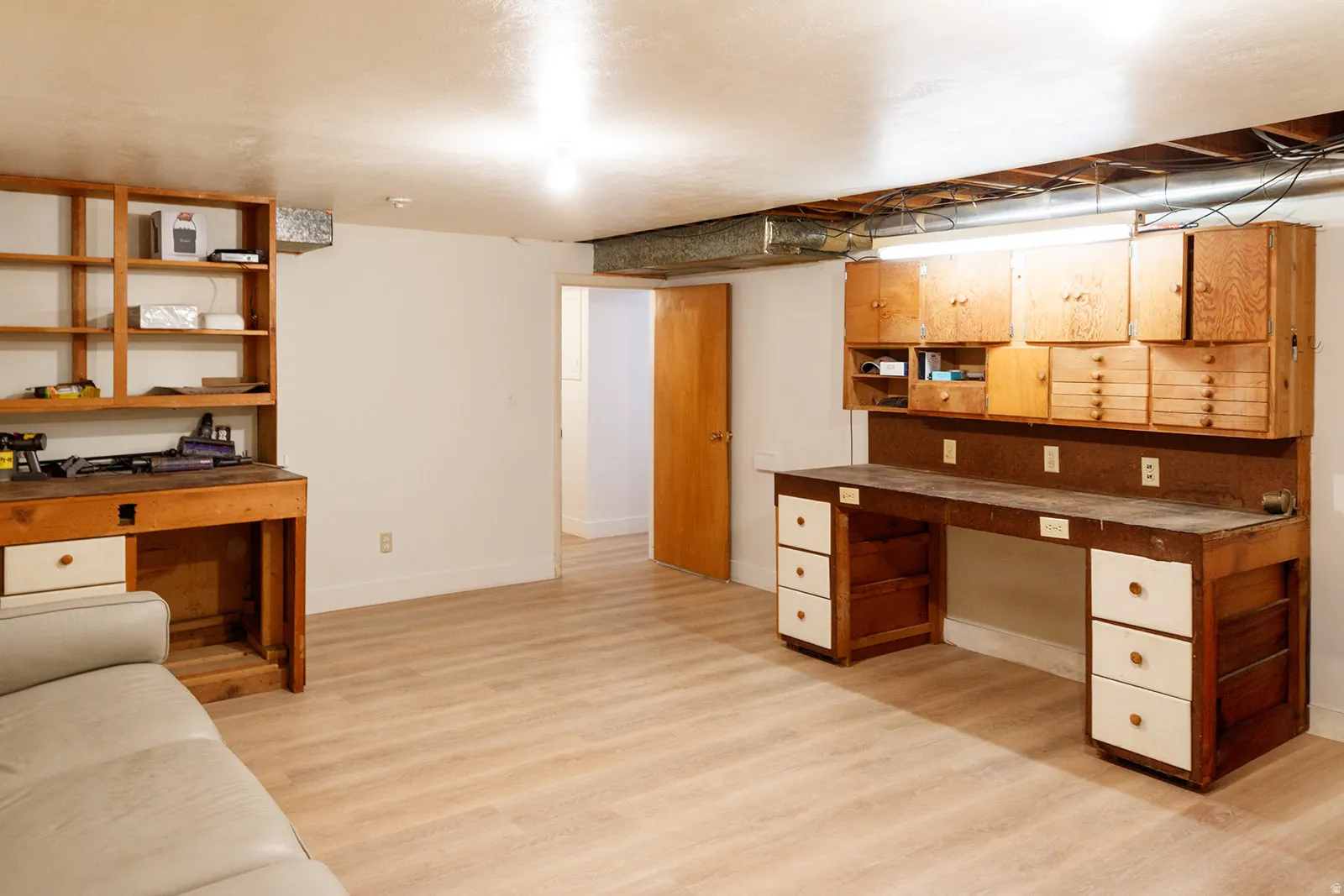 Unfurnished office with light wood-style flooring and baseboards