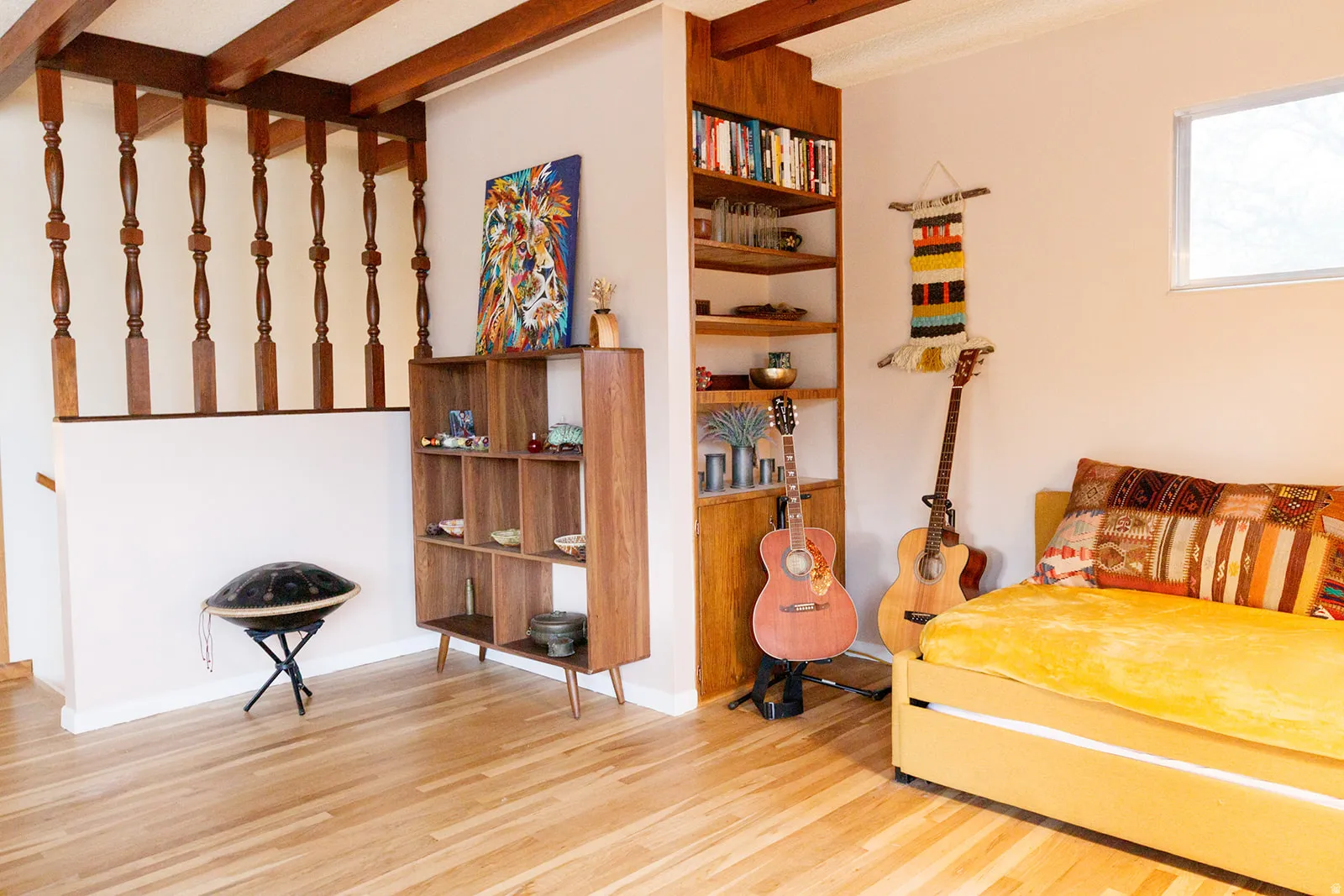 Bedroom featuring light wood-style floors and beamed ceiling