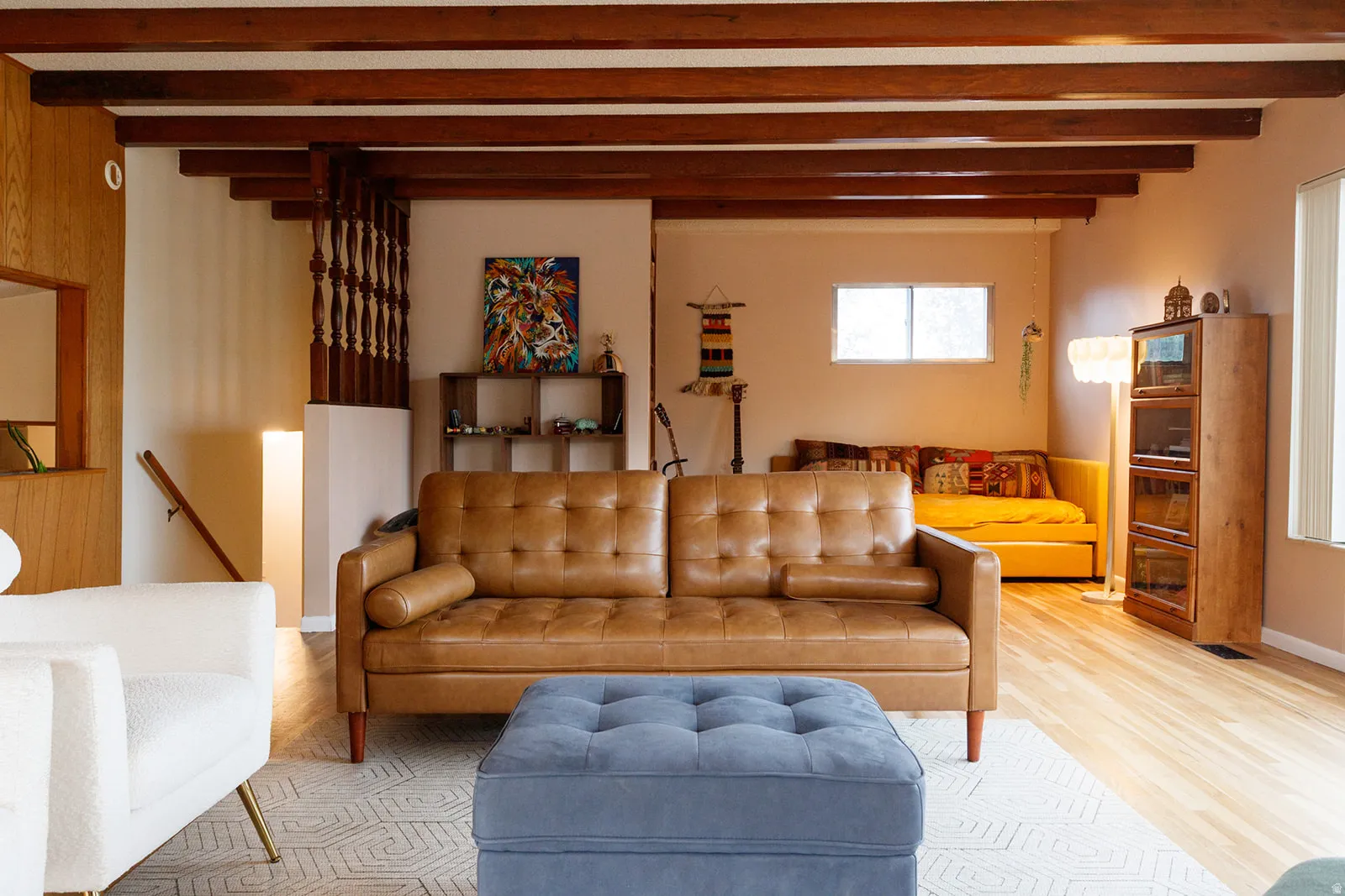 Living room featuring wood finished floors and beamed ceiling
