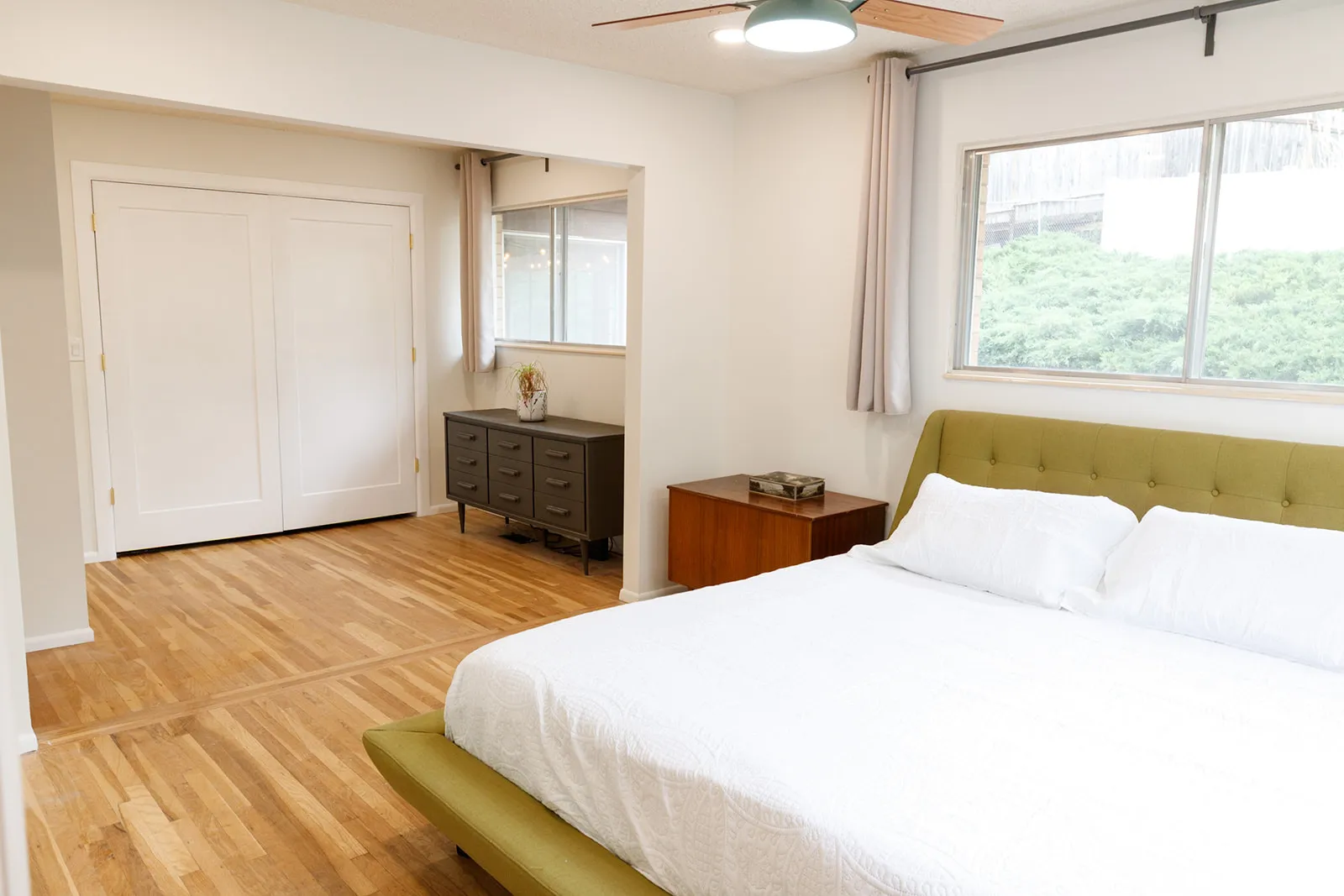Bedroom with light wood finished floors, a ceiling fan, and a closet